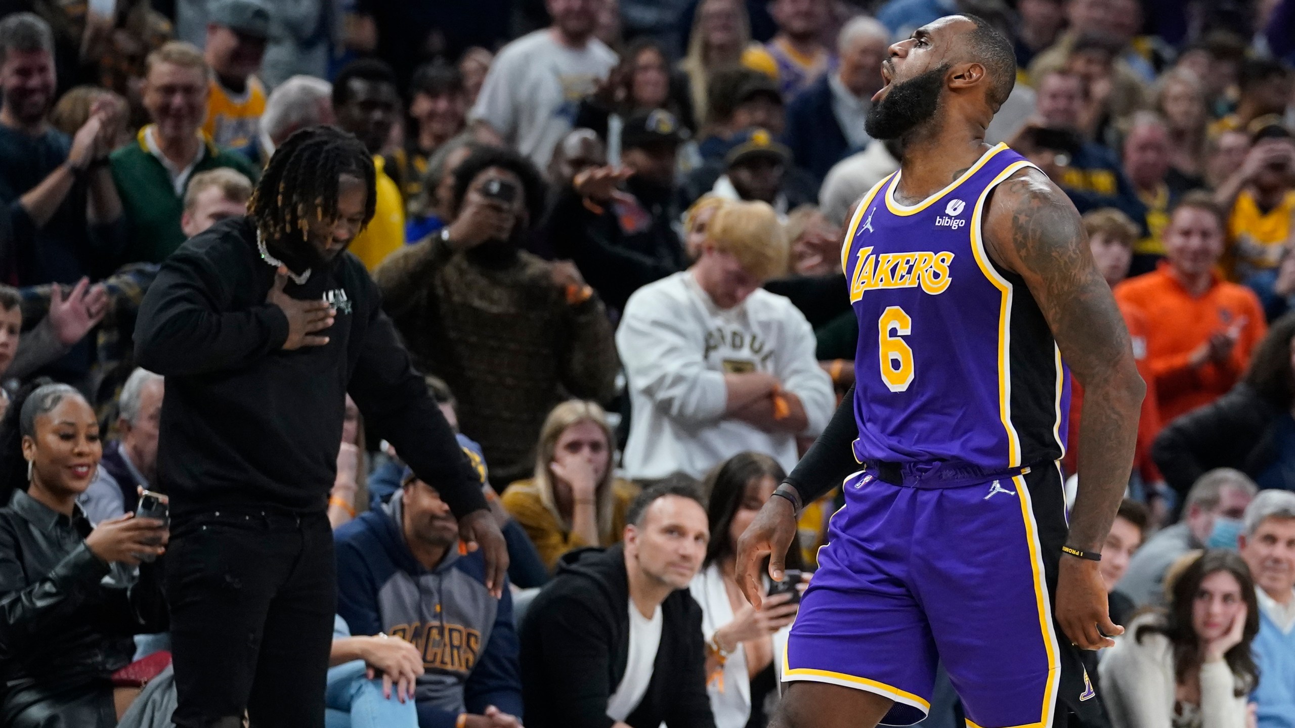 Los Angeles Lakers' LeBron James reacts after hitting a shot during overtime of in the team's NBA basketball game against the Indiana Pacers on Nov. 24, 2021, in Indianapolis. (AP Photo/Darron Cummings)