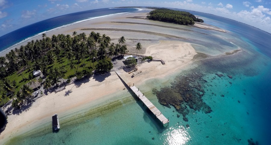 An aerial photo shows a small section of the atoll that has slipped beneath the water line only showing a small pile of rocks at low tide on Majuro Atoll in the Marshall Islands on Nov. 8, 2015. (AP Photo/Rob Griffith, File)