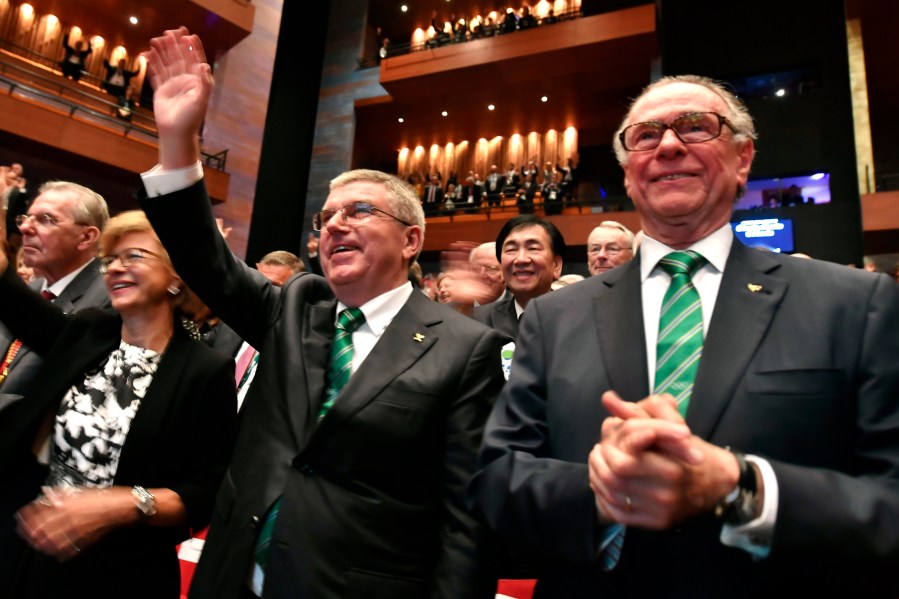 Then President of the Rio 2016 Olympic Organizing Committee Carlos Arthur Nuzman, right, and International Olympic Committee President Thomas Bach, second right, applaud during the opening ceremony of the 129th International Olympic Committee session, in Rio de Janeiro on August 1, 2016, ahead of the Rio 2016 Olympic Games. (Fabrice Coffrini/Pool Photo via AP, File)