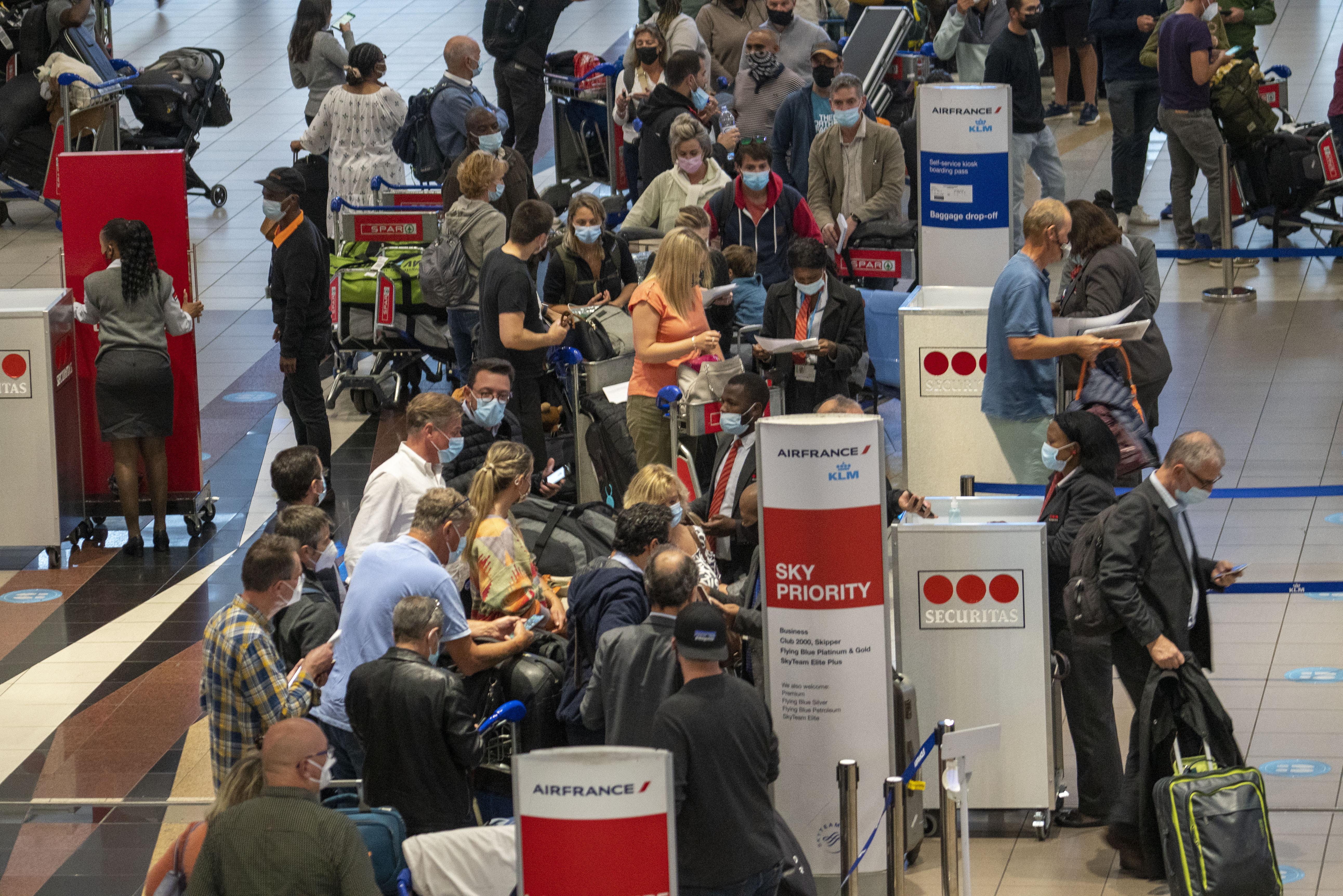 People queue to get on the Air France flight to Paris at OR Tambo's airport in Johannesburg, South Africa, Nov. 26, 2021. (AP Photo/Jerome Delay, File)