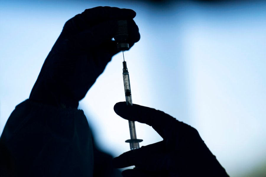 A medical staff member prepares the Pfizer-BioNTech COVID-19 vaccine at Tudor Ranch in Mecca, Calif. on Jan. 21, 2021. Merriam-Webster has declared vaccine its 2021 word of the year. (AP Photo/Jae C. Hong, File)