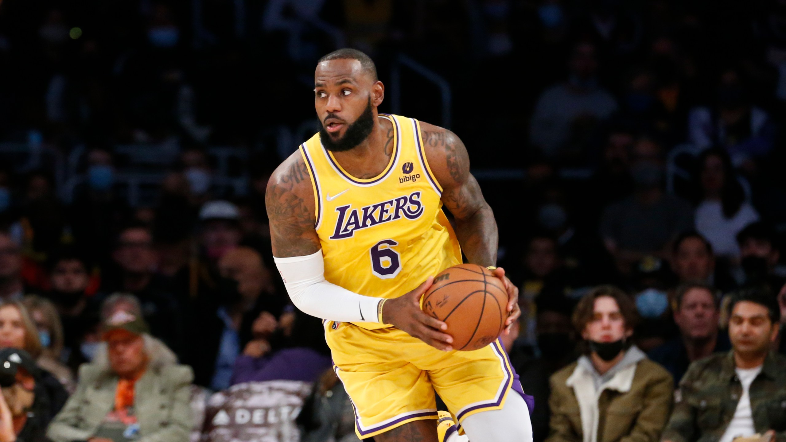 Los Angeles Lakers forward LeBron James dribbles against the Sacramento Kings during the first half of an NBA basketball game in Los Angeles, on Nov. 26, 2021. (Ringo H.W. Chiu/Associated Press)