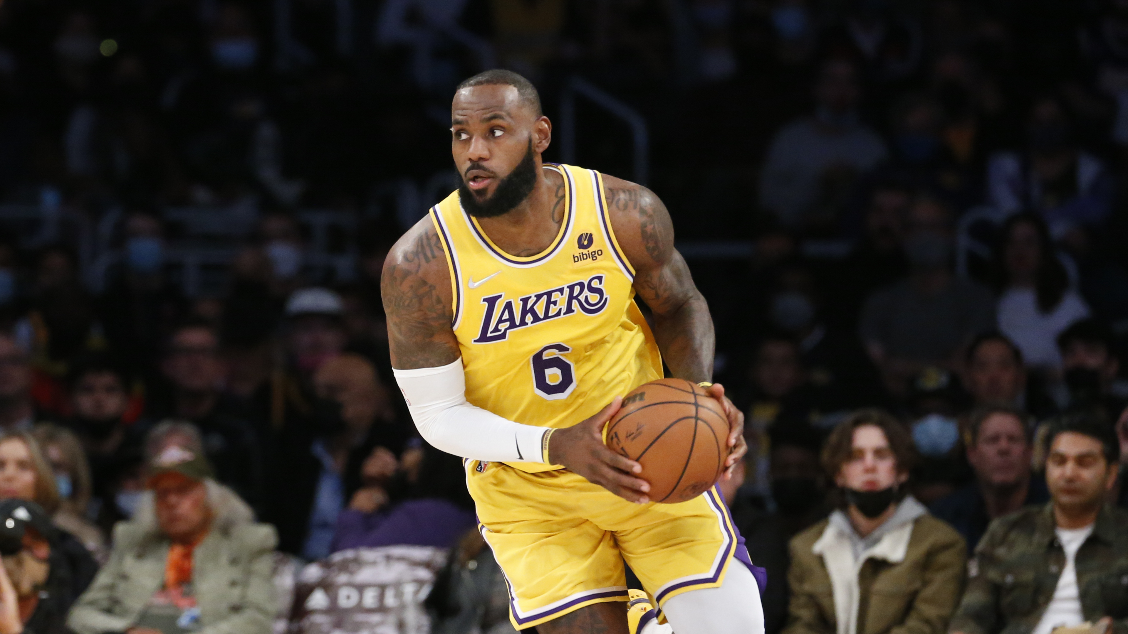 Los Angeles Lakers forward LeBron James dribbles against the Sacramento Kings during the first half of an NBA basketball game in Los Angeles, on Nov. 26, 2021. (Ringo H.W. Chiu/Associated Press)