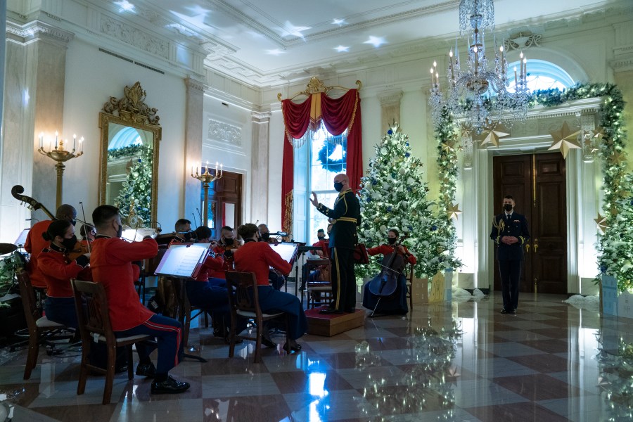 A Marine band plays Christmas music in the Grand Foyer of the White House during a press preview of the White House holiday decorations, Monday, Nov. 29, 2021, in Washington. (AP Photo/Evan Vucci)