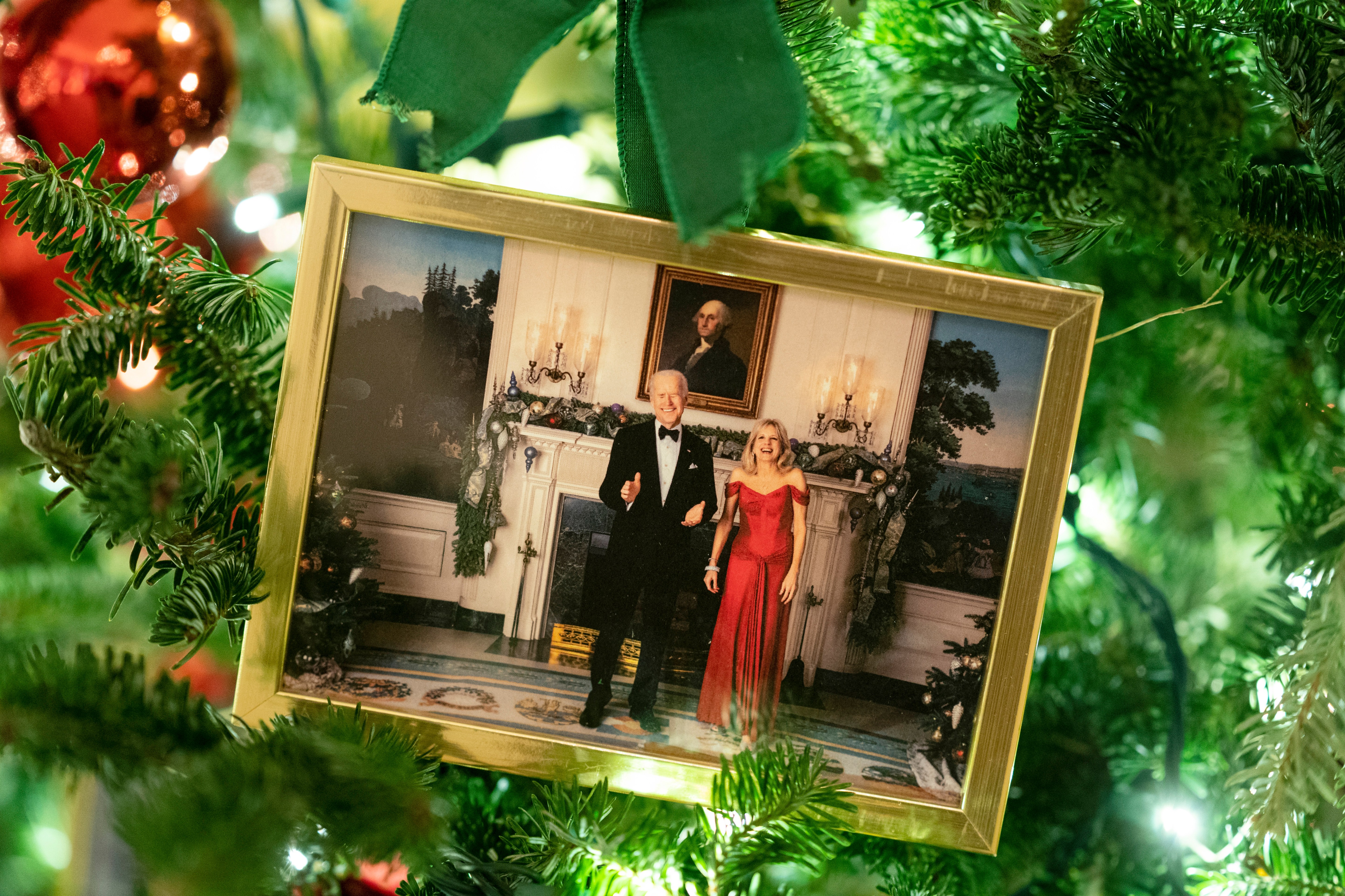 A photo of President Joe Biden and first lady Jill Biden sits in a Christmas tree in the State Dining Room of the White House during a press preview of the White House holiday decorations, Monday, Nov. 29, 2021, in Washington. (AP Photo/Evan Vucci)