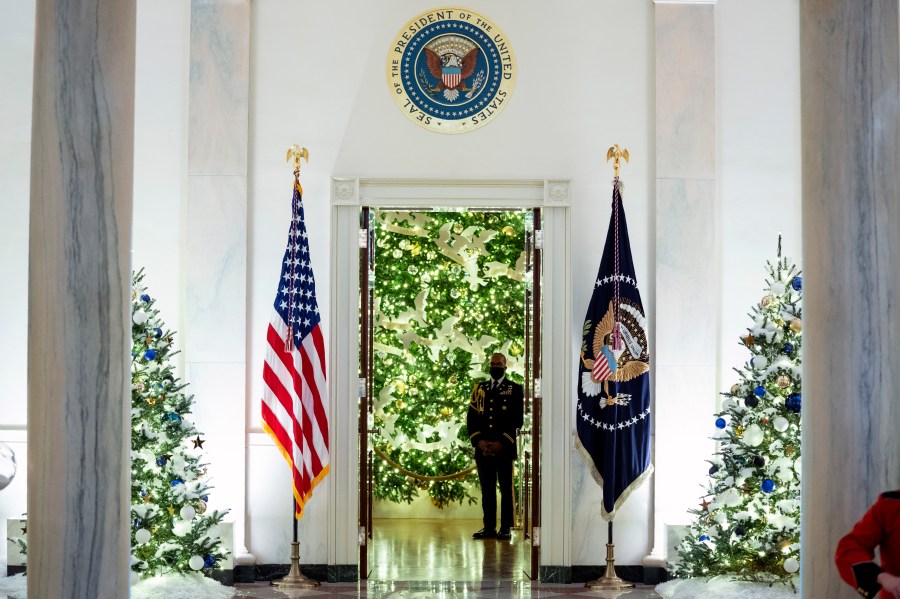 The Cross Hall of the White House is decorated for the holiday season during a press preview of the White House holiday decorations, Monday, Nov. 29, 2021, in Washington. (AP Photo/Evan Vucci)