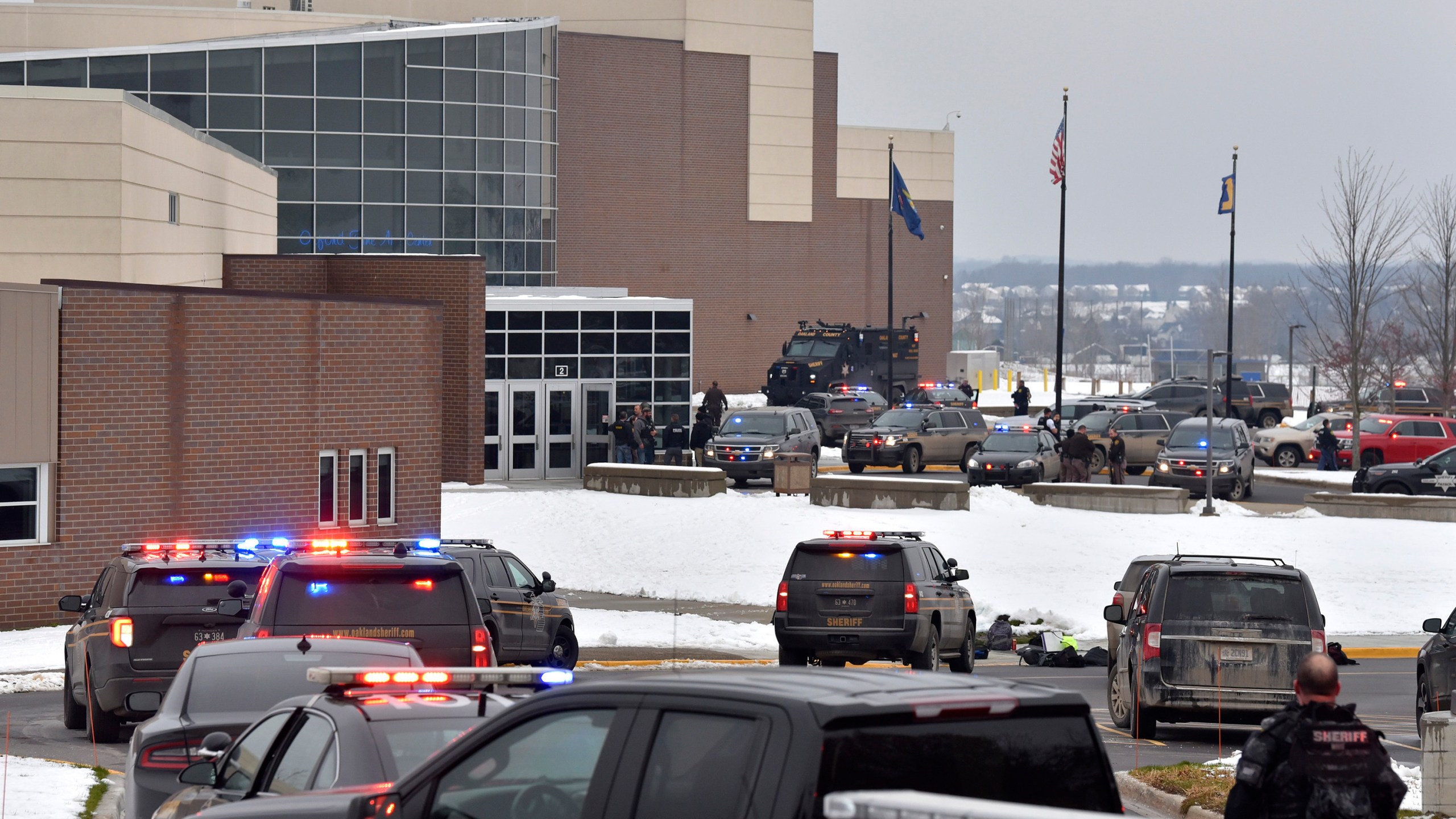 Dozens of police, fire, and EMS personnel work on the scene of a shooting at Oxford High School, Tuesday, Nov. 30, 2021, In Oxford Township, Mich. (Todd McInturf/The Detroit News via AP)