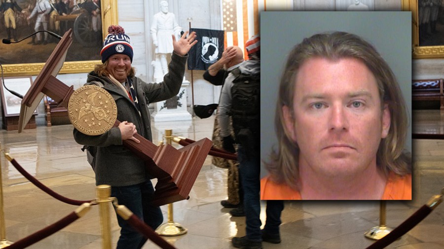 A pro-Trump protester carries the lectern of U.S. Speaker of the House Nancy Pelosi through the Roturnda of the U.S. Capitol Building after a pro-Trump mob stormed the building on January 06, 2021 in Washington, DC. (Win McNamee/Getty Images)