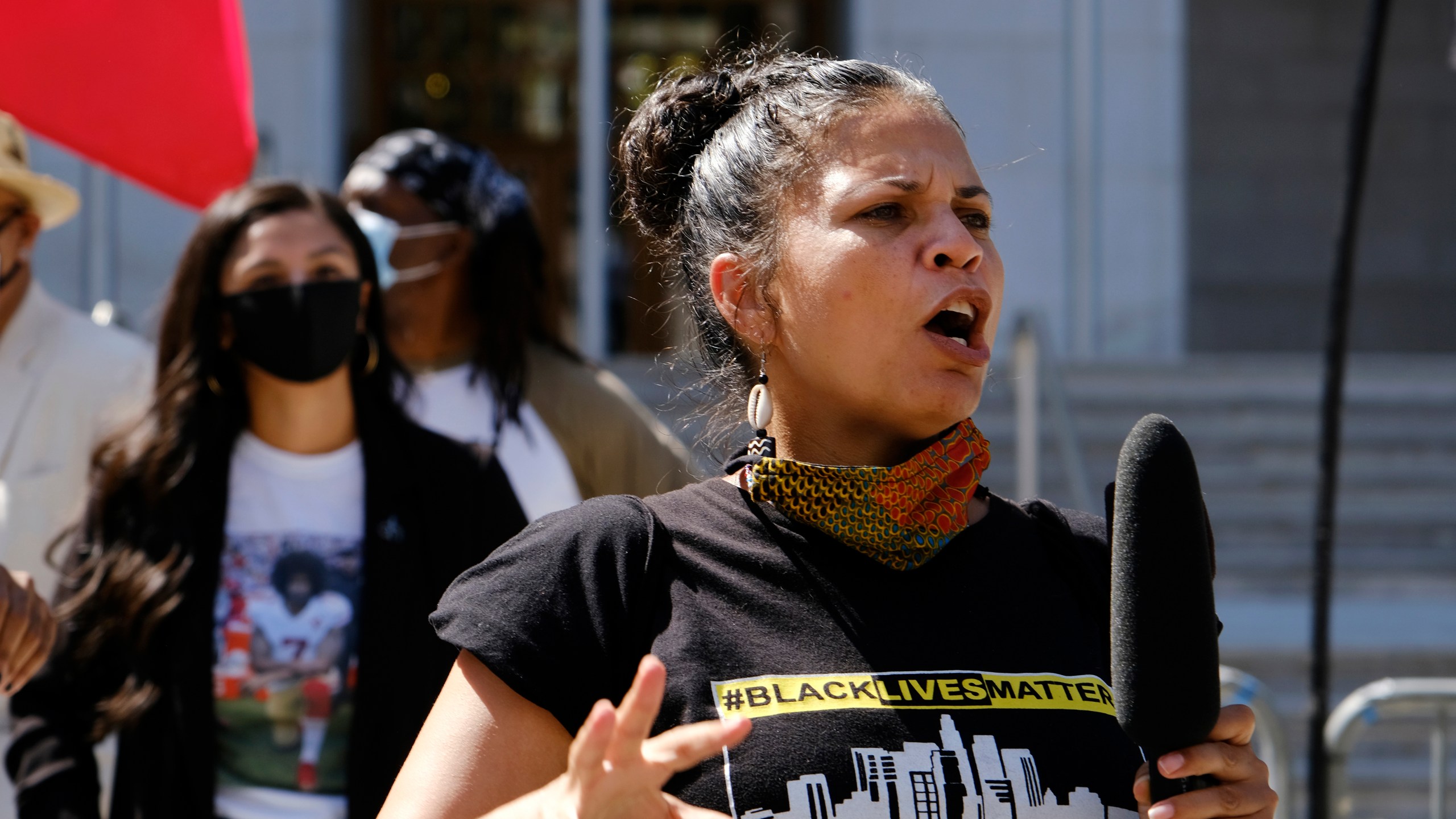 In this Aug. 5, 2020 file photo, Melina Abdullah speaks during a Black Lives Matter protest at the Hall of Justice in downtown Los Angeles. Authorities say three teenagers driven by racial hatred were behind hoax calls that brought major police responses to the home of Abdullah, a leading Black Lives Matter activist in Los Angeles. (AP Photo/Richard Vogel, File)