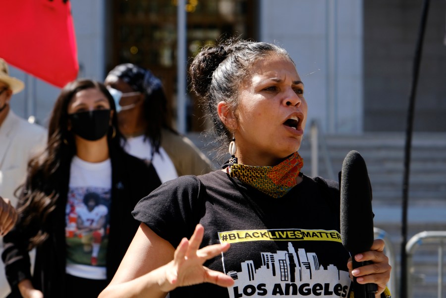 In this Aug. 5, 2020 file photo, Melina Abdullah speaks during a Black Lives Matter protest at the Hall of Justice in downtown Los Angeles. Authorities say three teenagers driven by racial hatred were behind hoax calls that brought major police responses to the home of Abdullah, a leading Black Lives Matter activist in Los Angeles. (AP Photo/Richard Vogel, File)