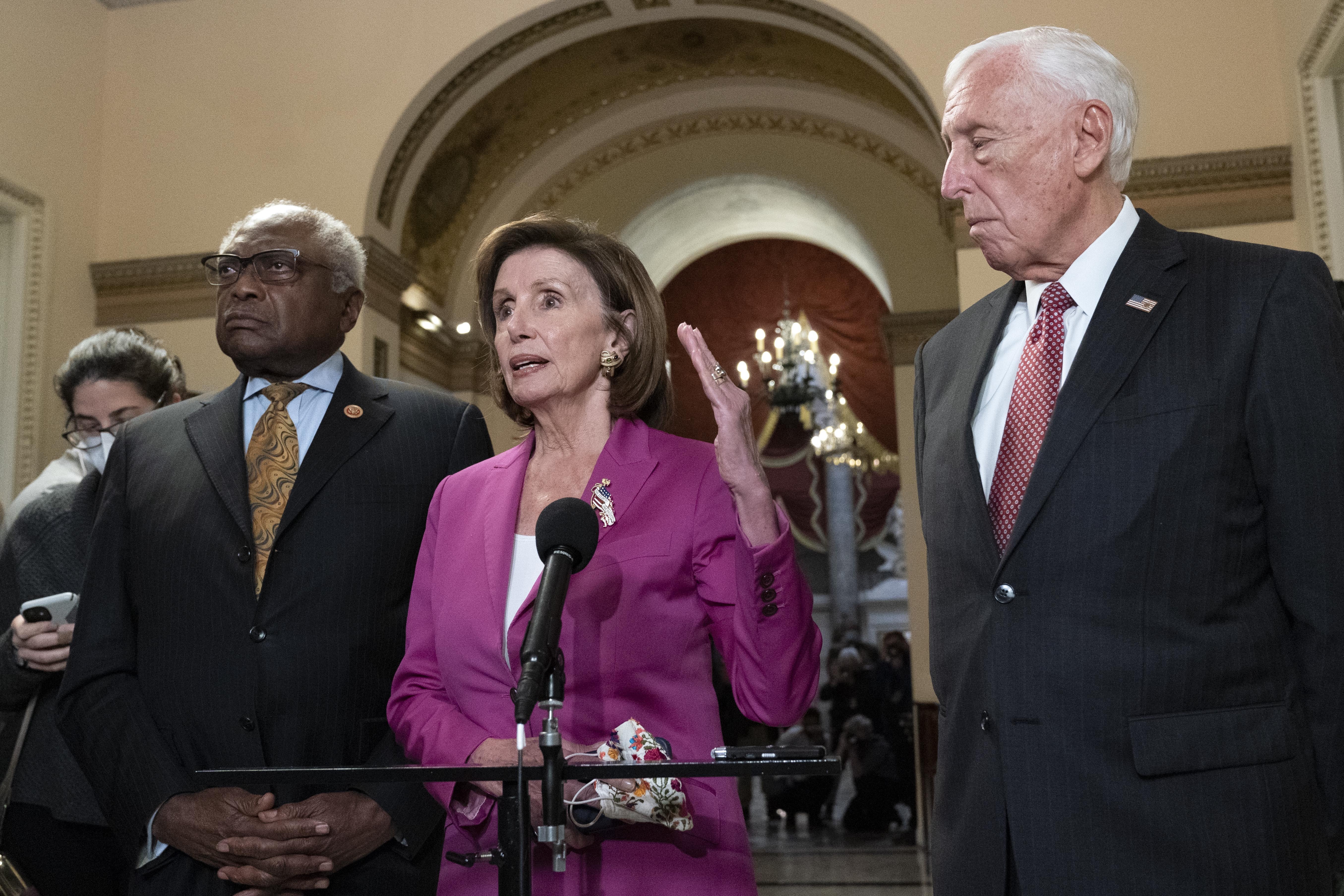 Speaker of the House Nancy Pelosi, D-Calif., accompanied by House Majority Whip James Clyburn, D-S.C., left and House Majority Leader Steny Hoyer D-Md. speaks to reporters at the Capitol in Washington, Friday, Nov. 5, 2021, as the House is considering President Joe Biden's $1.85 trillion-and-growing domestic policy package. (AP Photo/Jose Luis Magana)