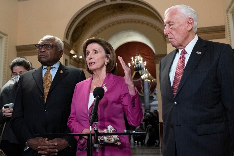 Speaker of the House Nancy Pelosi, D-Calif., accompanied by House Majority Whip James Clyburn, D-S.C., left and House Majority Leader Steny Hoyer D-Md. speaks to reporters at the Capitol in Washington, Friday, Nov. 5, 2021, as the House is considering President Joe Biden's $1.85 trillion-and-growing domestic policy package. (AP Photo/Jose Luis Magana)