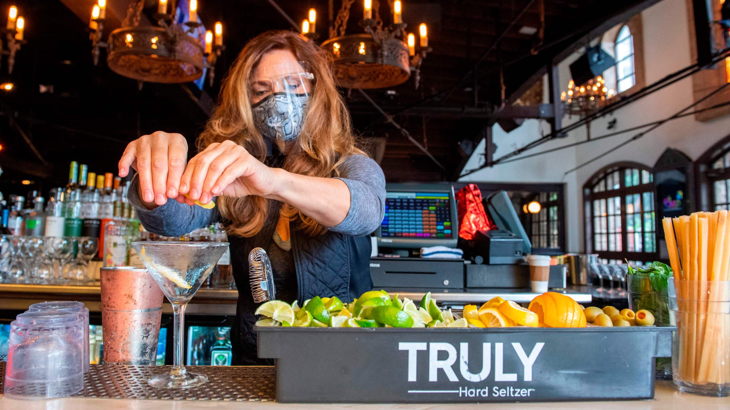 A bartender prepares some drinks at the outdoor seating area of The Abbey Food & Bar on Jan. 29, 2021 in West Hollywood. (VALERIE MACON/AFP via Getty Images)