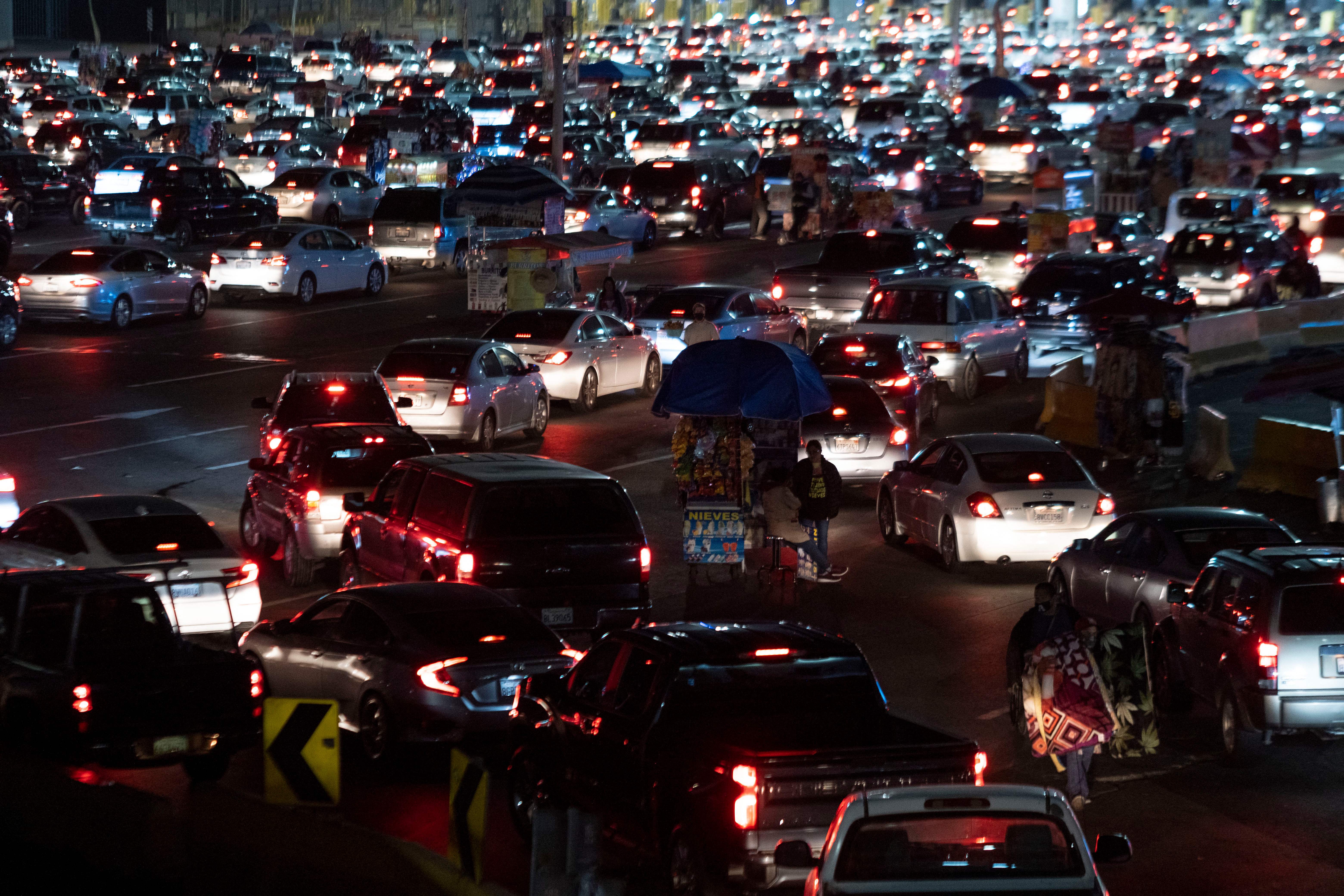 Cars queue to cross the border at San Ysidro crossing port on the Mexico-United States border in Tijuana, Baja California state, Mexico, on November 7, 2021.. (GUILLERMO ARIAS/AFP via Getty Images)