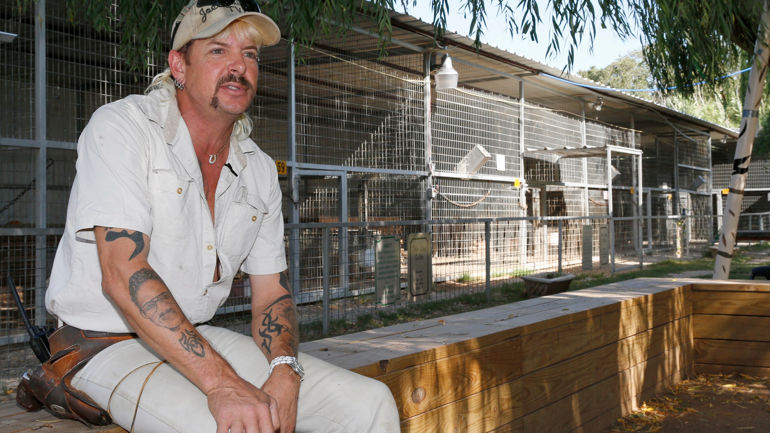 In this Aug. 28, 2013, file photo, Joseph Maldonado-Passage, also known as Joe Exotic, is seen at the zoo he used to run in Wynnewood, Okla. The former zookeeper has been transferred to a medical facility in North Carolina for federal inmates after a cancer diagnosis, according to his attorney. (AP Photo/Sue Ogrocki, File)