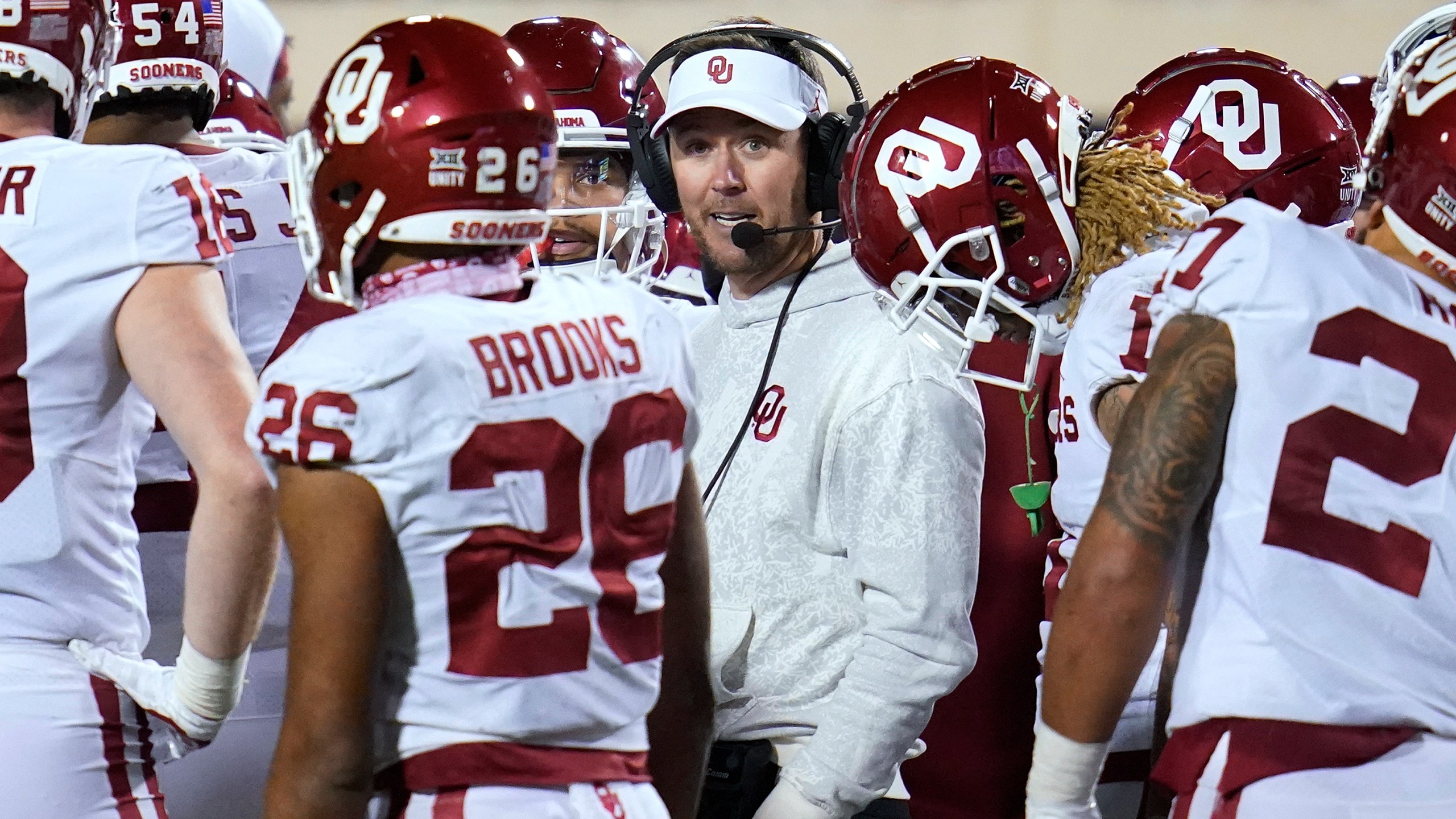 Oklahoma head coach Lincoln Riley talks with his players during the second half of an NCAA college football game against Oklahoma State, Saturday, Nov. 27, 2021, in Stillwater, Okla. (AP Photo/Sue Ogrocki)