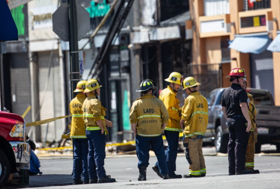 Los Angeles firefighters and other officials investigate an explosion and fire in the Little Tokyo area of downtown L.A. on May 17, 2020. (Jason Armond / Los Angeles Times)