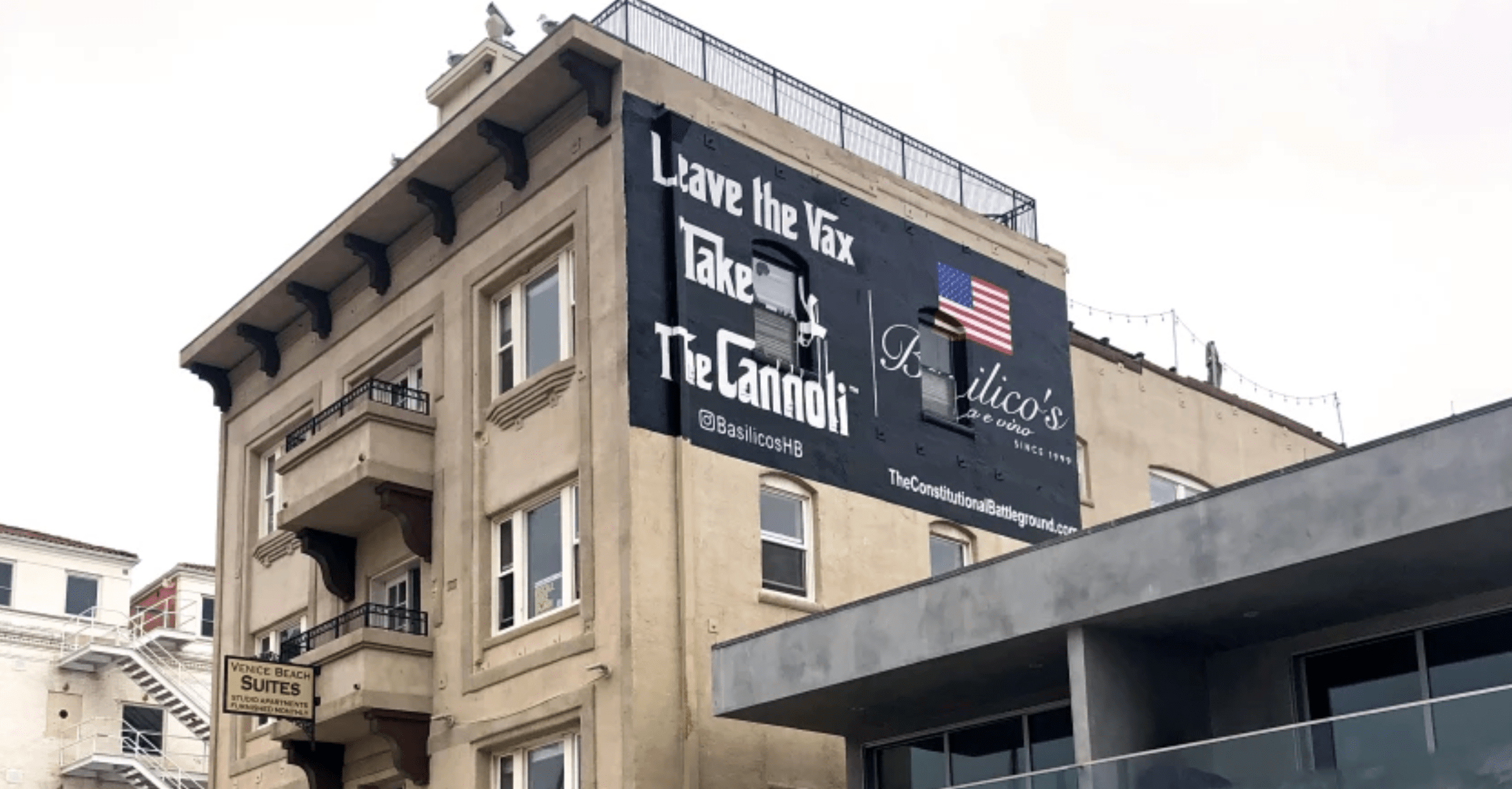 Tony Roman, an Orange County business owner known as a provocateur on COVID-19 safety protocols, posted an anti-vaccination message on the side of a Venice apartment building.(James Rainey / Los Angeles Times)