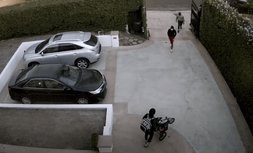 LAPD released surveillance video of a woman who was robbed in the driveway of her home in Hancock Park on Nov. 28, 2021.