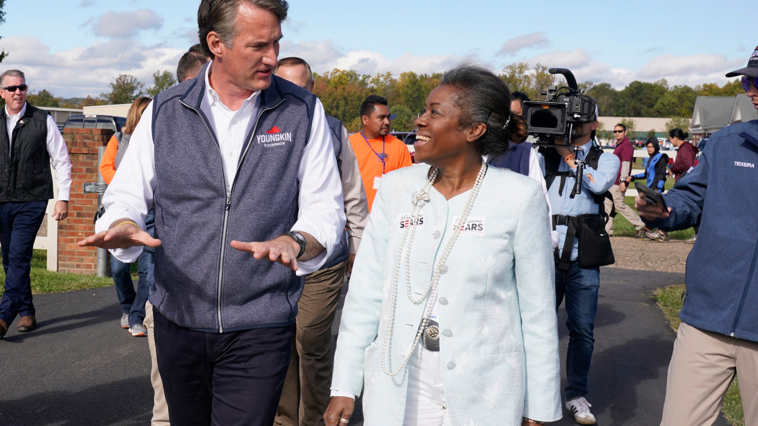 Republican gubernatorial candidate Glenn Youngkin speaks with Lt. Gov. candidate Winsome Sears after a rally in Fredericksburg, Va., Saturday, Oct. 30, 2021. Youngkin will face Democrat former Gov. Terry McAuliffe in the November election. (AP Photo/Steve Helber)