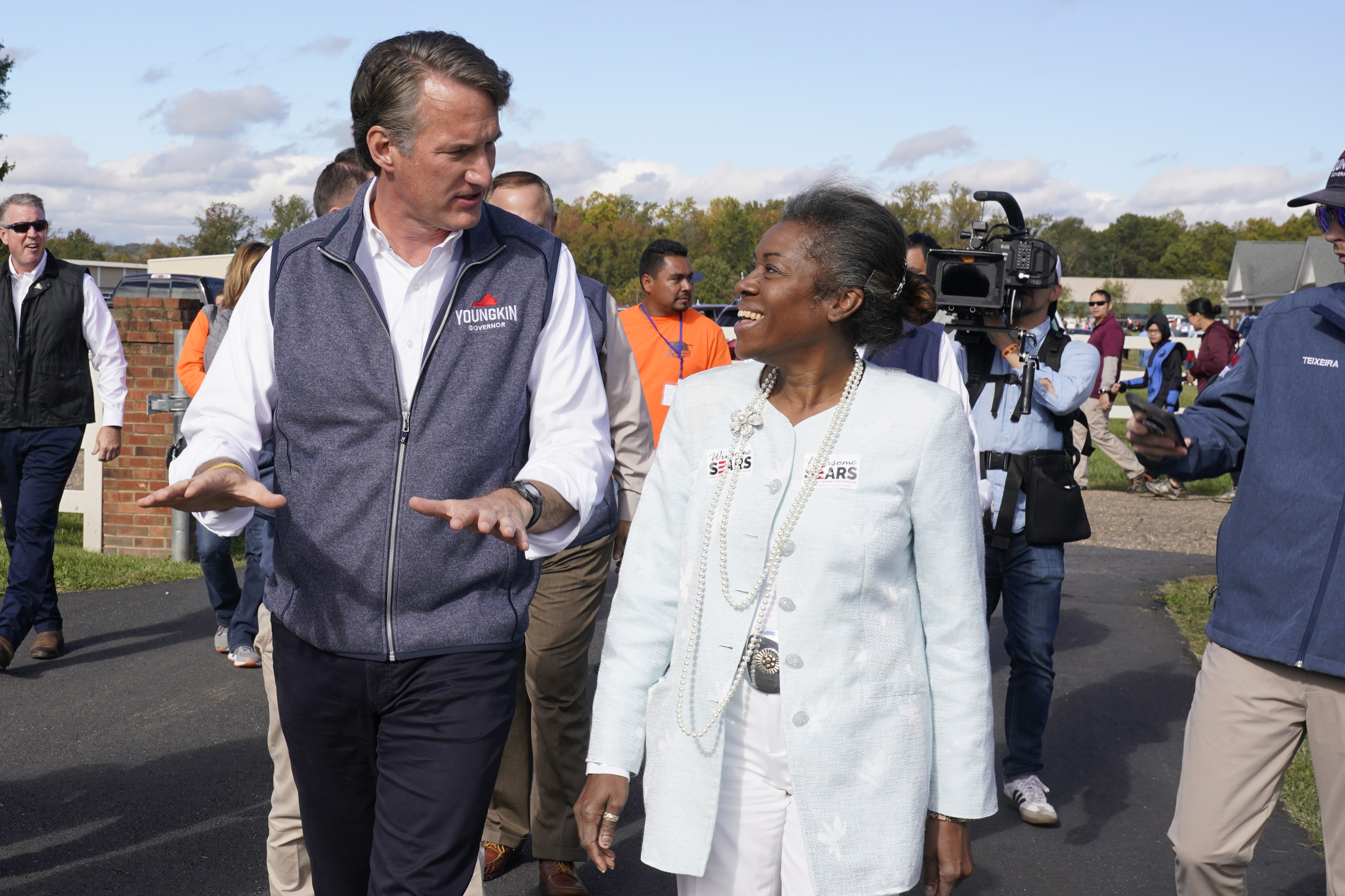 Republican gubernatorial candidate Glenn Youngkin speaks with Lt. Gov. candidate Winsome Sears after a rally in Fredericksburg, Va., Saturday, Oct. 30, 2021. Youngkin will face Democrat former Gov. Terry McAuliffe in the November election. (AP Photo/Steve Helber)