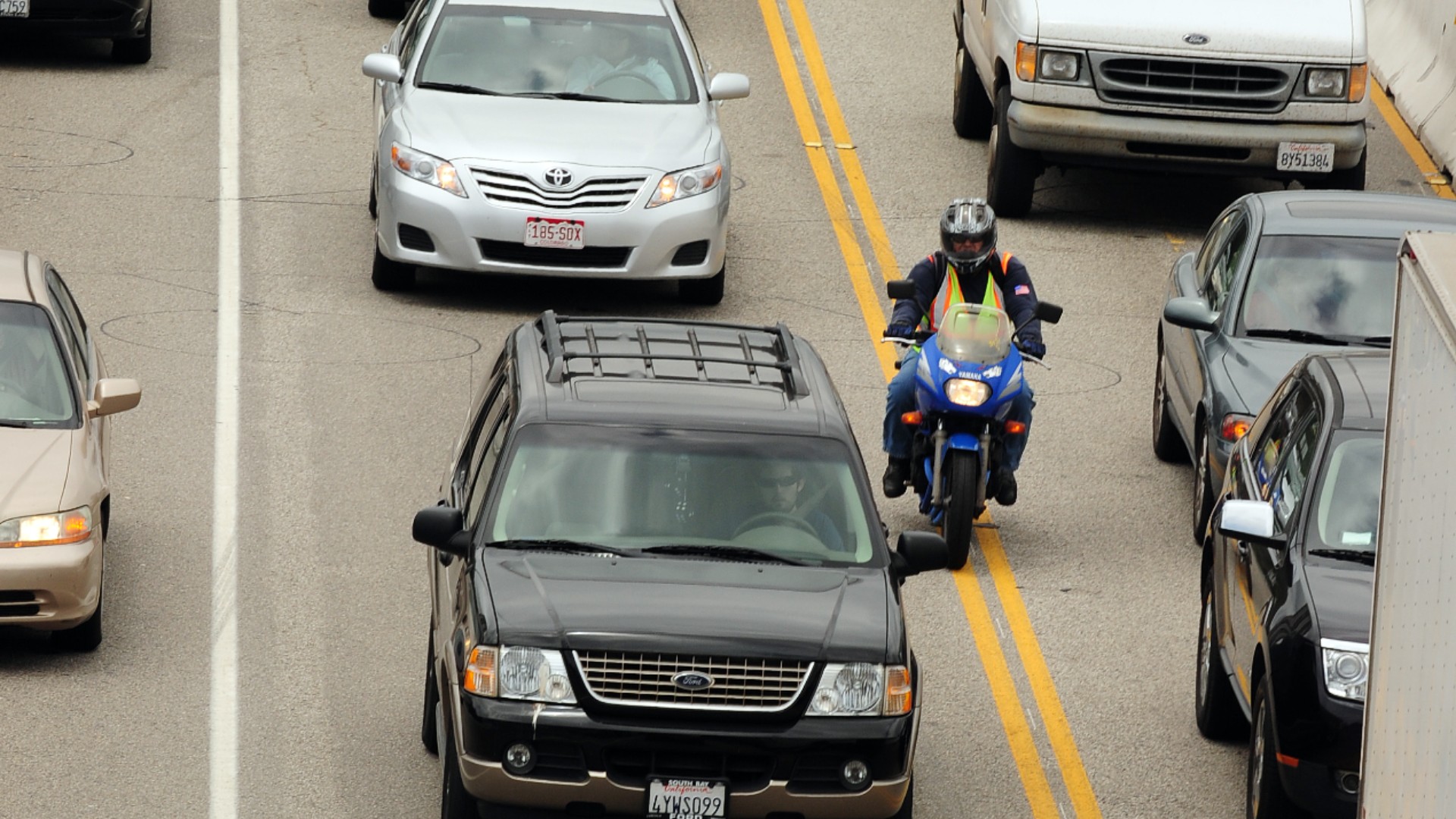 A motorcyclist splits lanes as he drives south on the 405 freeway at the Sunset Boulevard overpass in Los Angeles on July 14, 2011. (ROBYN BECK/AFP via Getty Images)