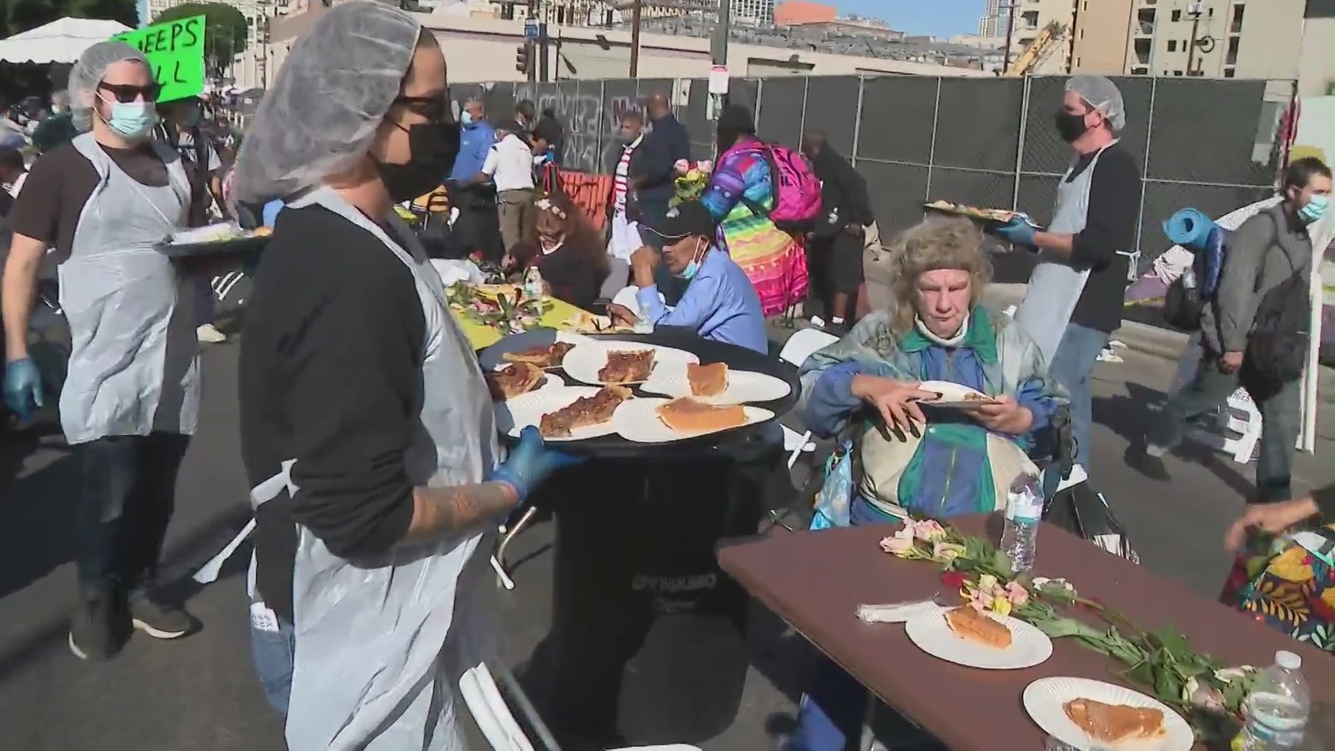 Volunteers with the Midnight Mission serve Thanksgiving meals at Skid Row in downtown Los Angeles on Nov. 25, 2021. (KTLA)