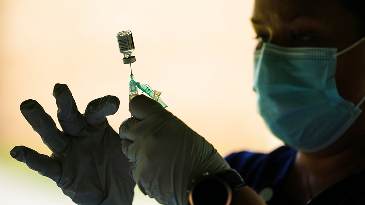 In this Sept. 14, 2021, file photo, a syringe is prepared with the Pfizer COVID-19 vaccine at a clinic at the Reading Area Community College in Reading, Pa. (AP Photo/Matt Rourke, File)