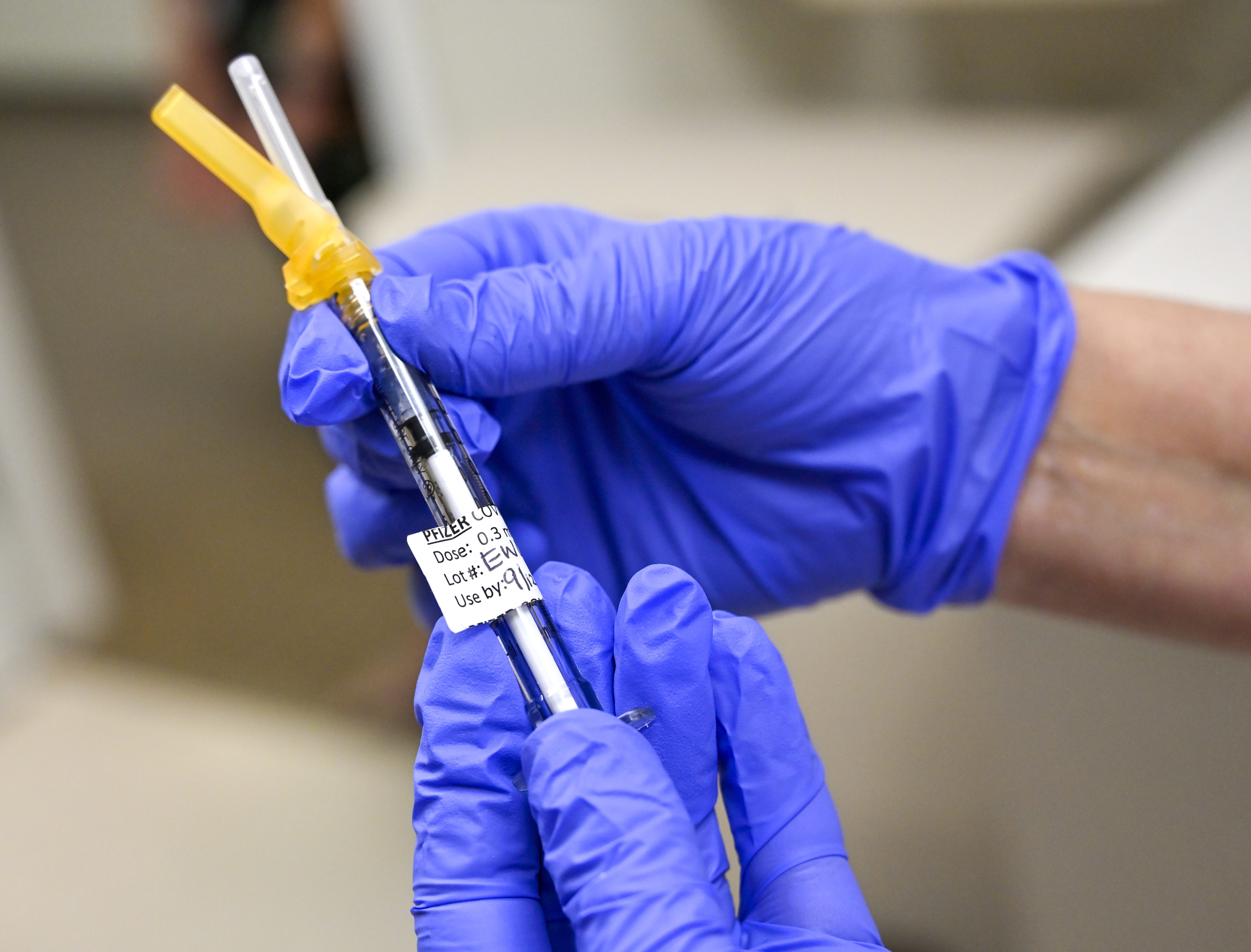 Nurse Mary Ezzat prepares to administer a Pfizer COVID-19 booster shot to Jessica M., Thursday, Aug. 19, 2021, at UCI Medical Center in Orange, Calif. (Jeff Gritchen/The Orange County Register via AP)