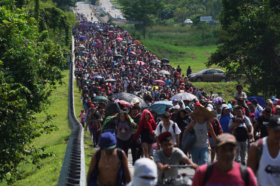 Migrants arrive in Villa Comaltitlan, Chiapas state, Mexico, Oct. 27, 2021, as they continue their journey through Mexico to the U.S. border. The Biden administration struck agreement with Mexico to reinstate a Trump-era border policy next week that forces asylum-seekers to wait in Mexico for hearings in U.S. immigration court, U.S. officials said Thursday. (AP Photo/Marco Ugarte, File)