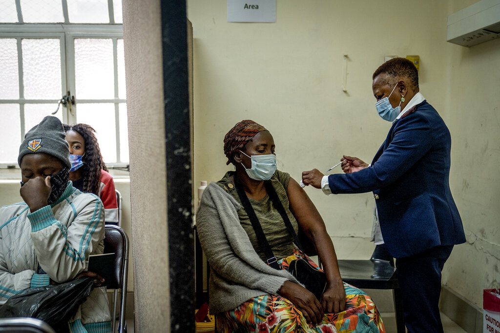 A woman is vaccinated against COVID-19 at the Hillbrow Clinic in Johannesburg, South Africa, Monday Dec. 6, 2021. (AP Photo/ Shiraaz Mohamed)