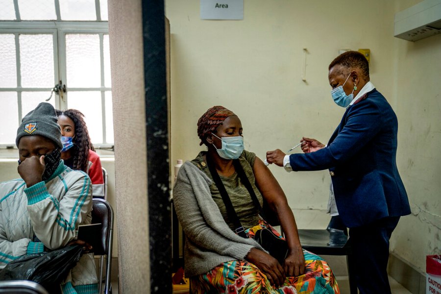 A woman is vaccinated against COVID-19 at the Hillbrow Clinic in Johannesburg, South Africa, Monday Dec. 6, 2021. (AP Photo/ Shiraaz Mohamed)