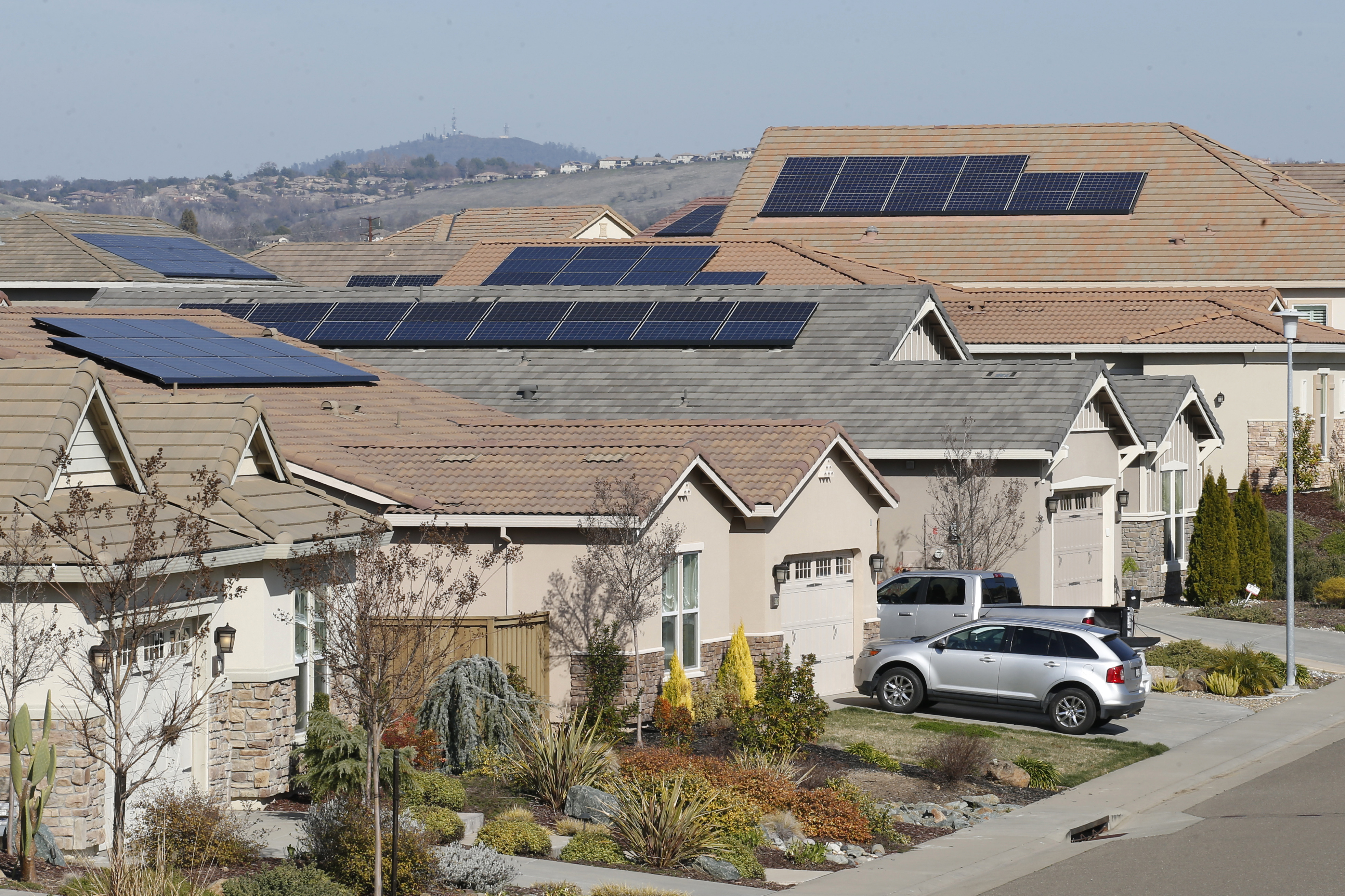 This photo taken Feb. 12, 2020, shows solar panels on rooftops of a housing development in Folsom, Calif. (AP Photo/Rich Pedroncelli, File)