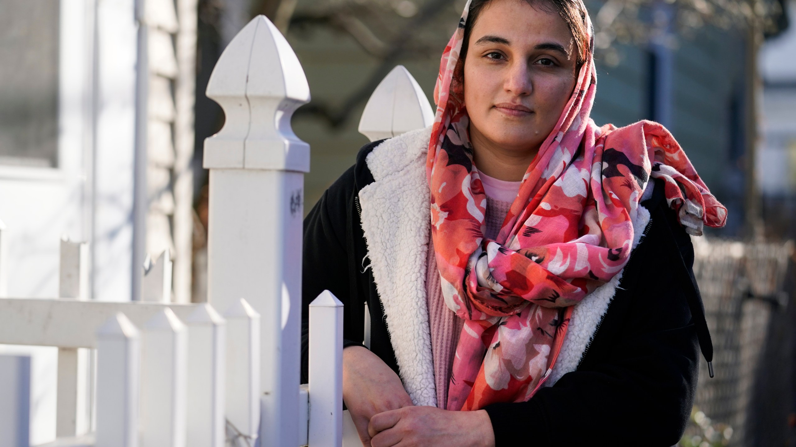 Haseena Niazi, a 24-year-old from Afghanistan, poses outside her home, Friday, Dec. 17, 2021, north of Boston. Niazi received a letter from the federal government denying her fiancé's humanitarian parole application earlier in the month. Her fiance, who she asked not to be named over concerns about his safety, had received threats from Taliban members for working on women's health issues at a hospital north of Kabul. (AP Photo/Charles Krupa)