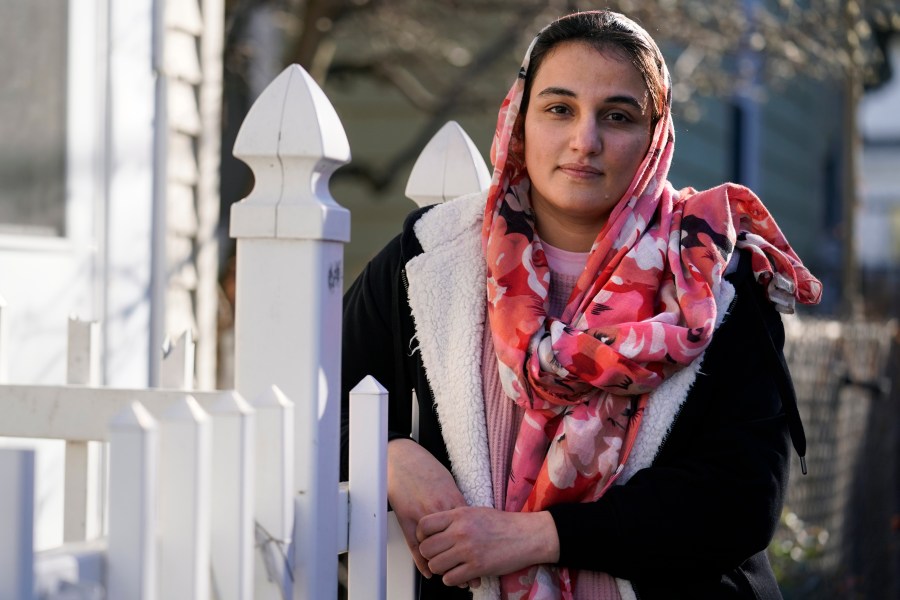 Haseena Niazi, a 24-year-old from Afghanistan, poses outside her home, Friday, Dec. 17, 2021, north of Boston. Niazi received a letter from the federal government denying her fiancé's humanitarian parole application earlier in the month. Her fiance, who she asked not to be named over concerns about his safety, had received threats from Taliban members for working on women's health issues at a hospital north of Kabul. (AP Photo/Charles Krupa)