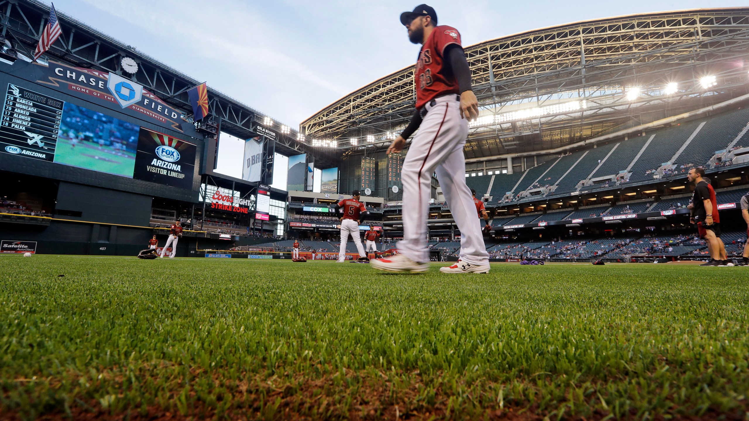 Arizona Diamondbacks' Steven Souza Jr. walks on new synthetic grass at Chase Field before a spring training baseball game against the Chicago White Sox, March 25, 2019, in Phoenix, Ariz. The Diamondbacks ripped out the grass at the field ahead of the 2019 season, replacing it with the artificial turf. The team says they've saved about 16 million gallons of water because of it. (AP Photo/Elaine Thompson, File)