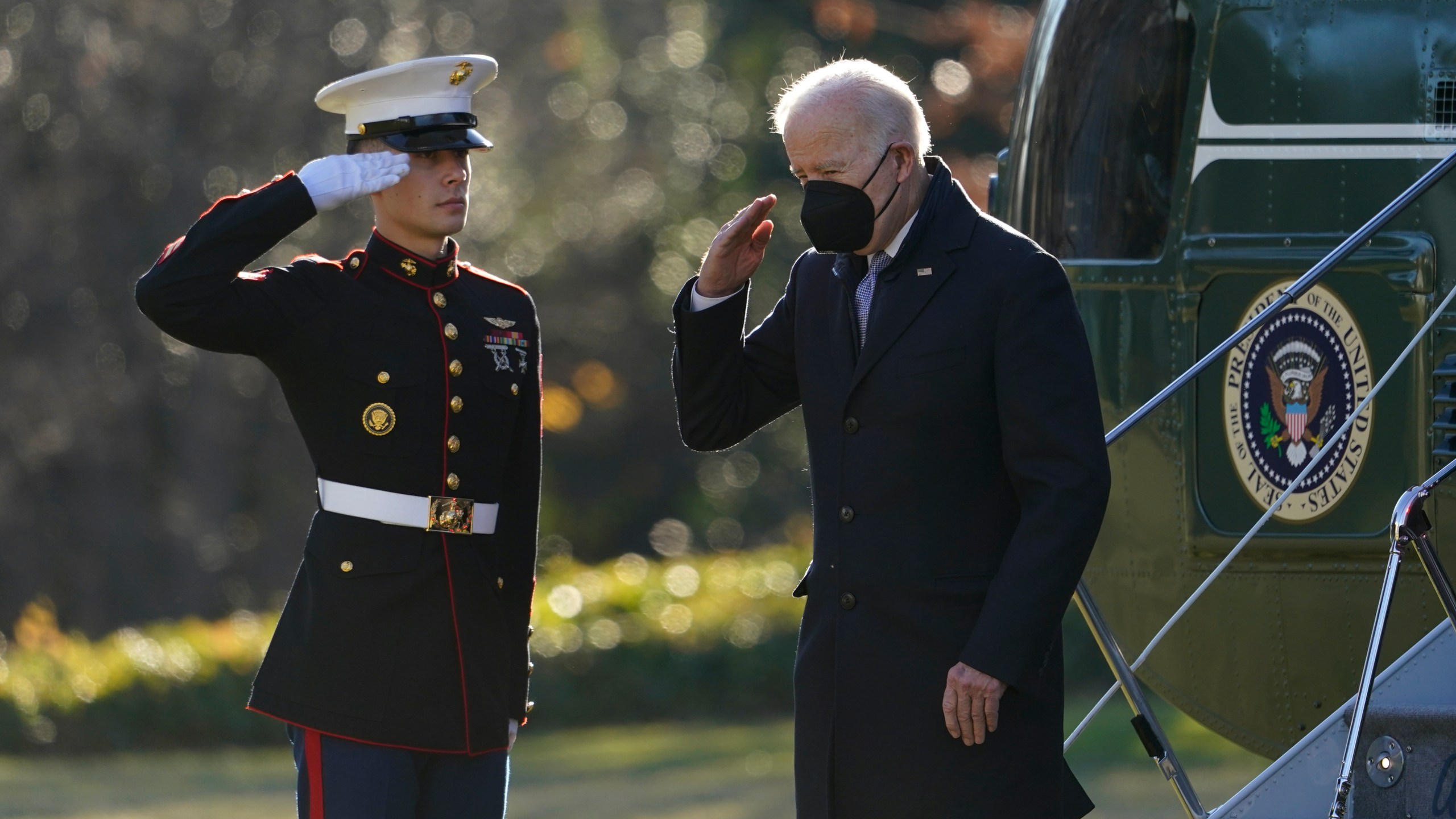 President Joe Biden salutes as he steps off Marine One on the South Lawn of the White House in Washington, Monday, Dec. 20, 2021. Biden is returning to Washington after spending the weekend at his home in Delaware. (AP Photo/Patrick Semansky)