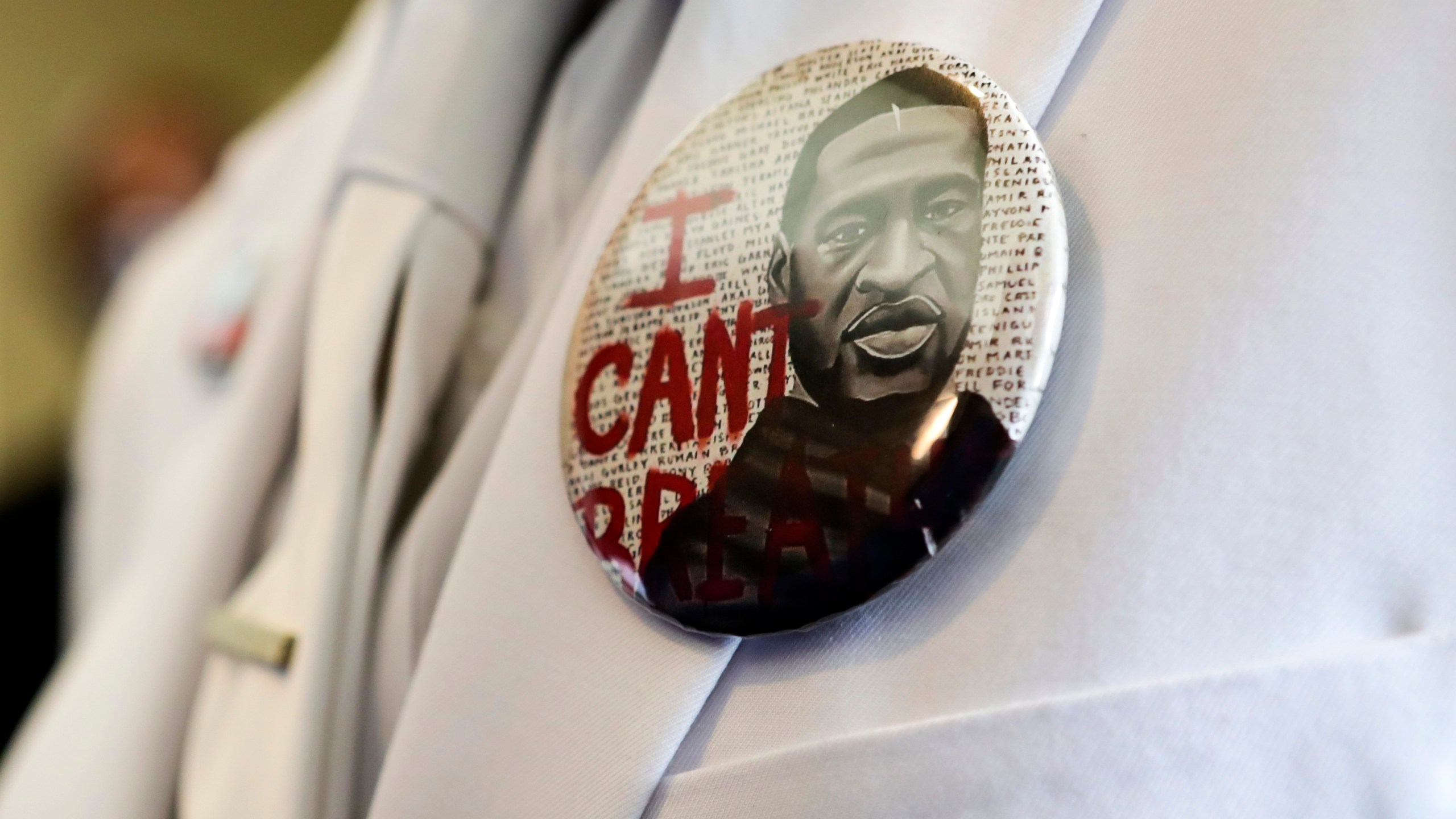 A button that reads "I can't breathe," adorns the jacket of a mourner before the funeral for George Floyd June 9, 2020, in Houston. (Godofredo A. Vásquez/Houston Chronicle via AP, Pool)