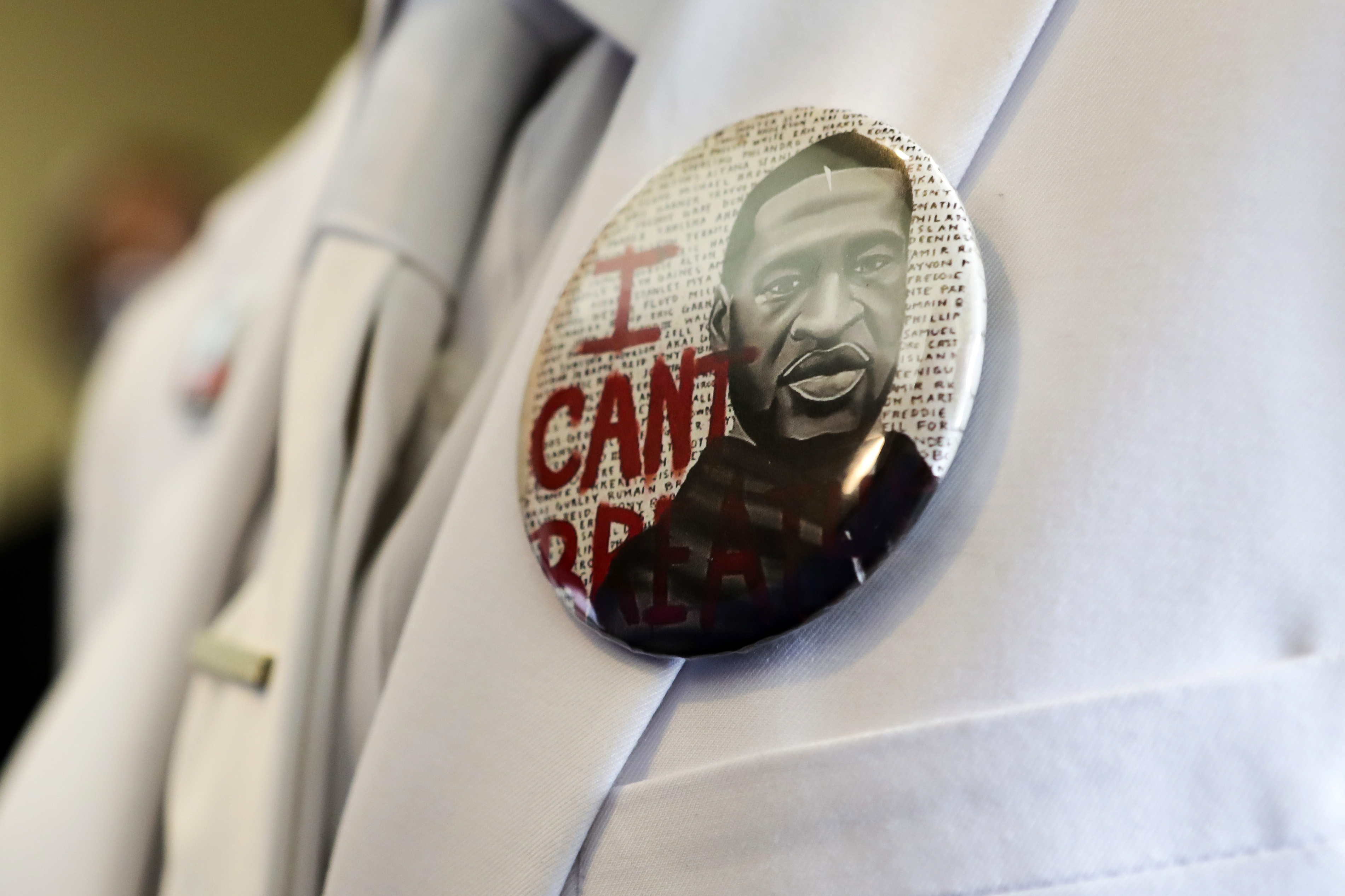 A button that reads "I can't breathe," adorns the jacket of a mourner before the funeral for George Floyd June 9, 2020, in Houston. (Godofredo A. Vásquez/Houston Chronicle via AP, Pool)