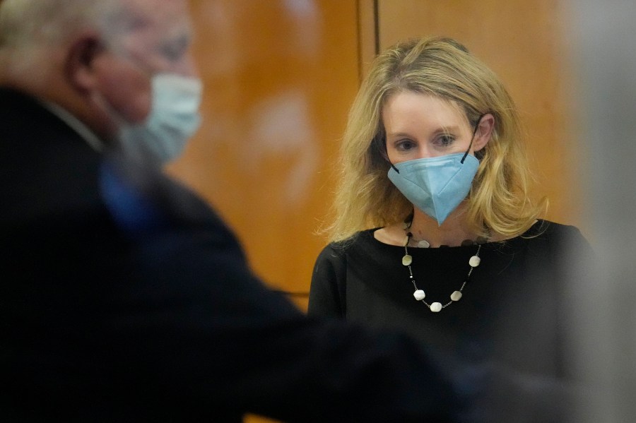 Former Theranos CEO Elizabeth Holmes walks into the Robert F. Peckham Federal Building and U.S. Courthouse for her trial in San Jose, Calif., on Dec. 21, 2021. (AP Photo/Tony Avelar)