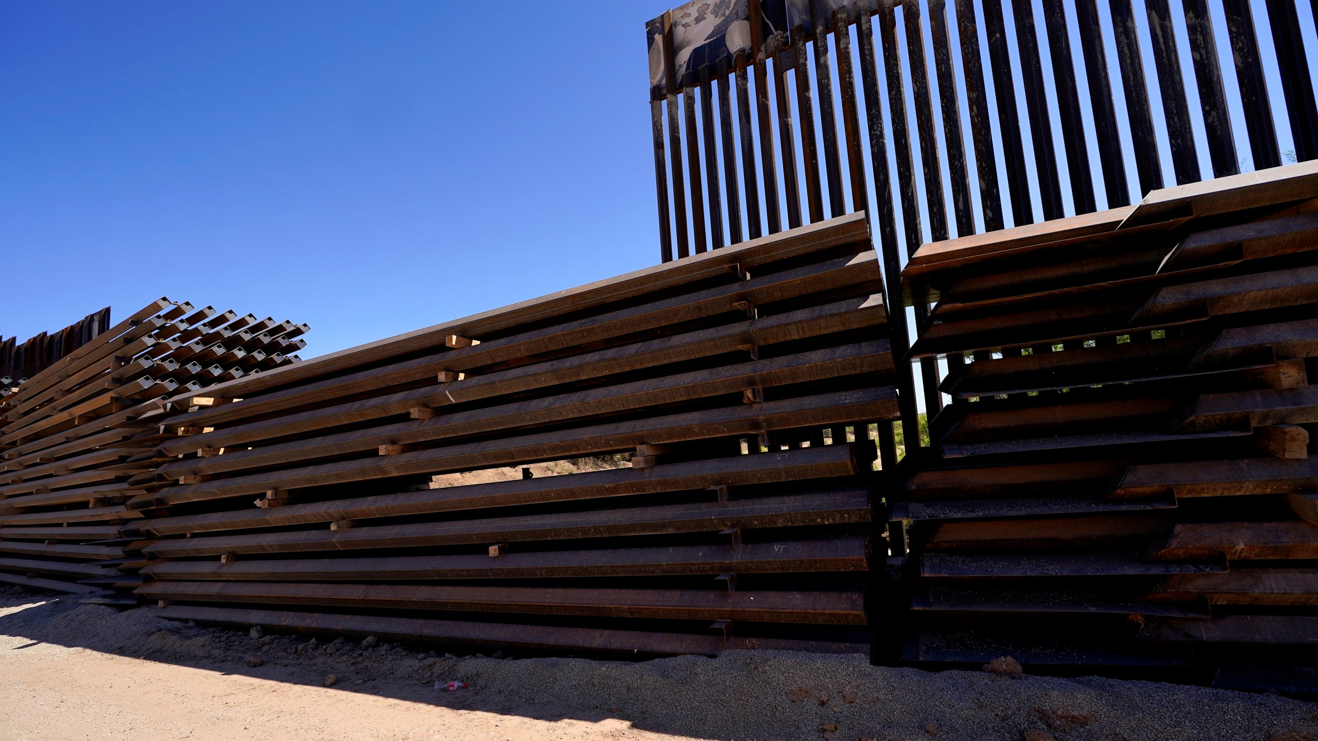 Abandoned border wall construction material is used to close a gap in the newly constructed border wall on May 19, 2021, near Sasabe, Ariz. The Department of Homeland Security Secretary Alejandro Mayorkas announced DHS will use border funding to close wall gaps in areas of Arizona, California and Texas by border construction started by the Trump administration. (Ross D. Franklin/Associated Press)