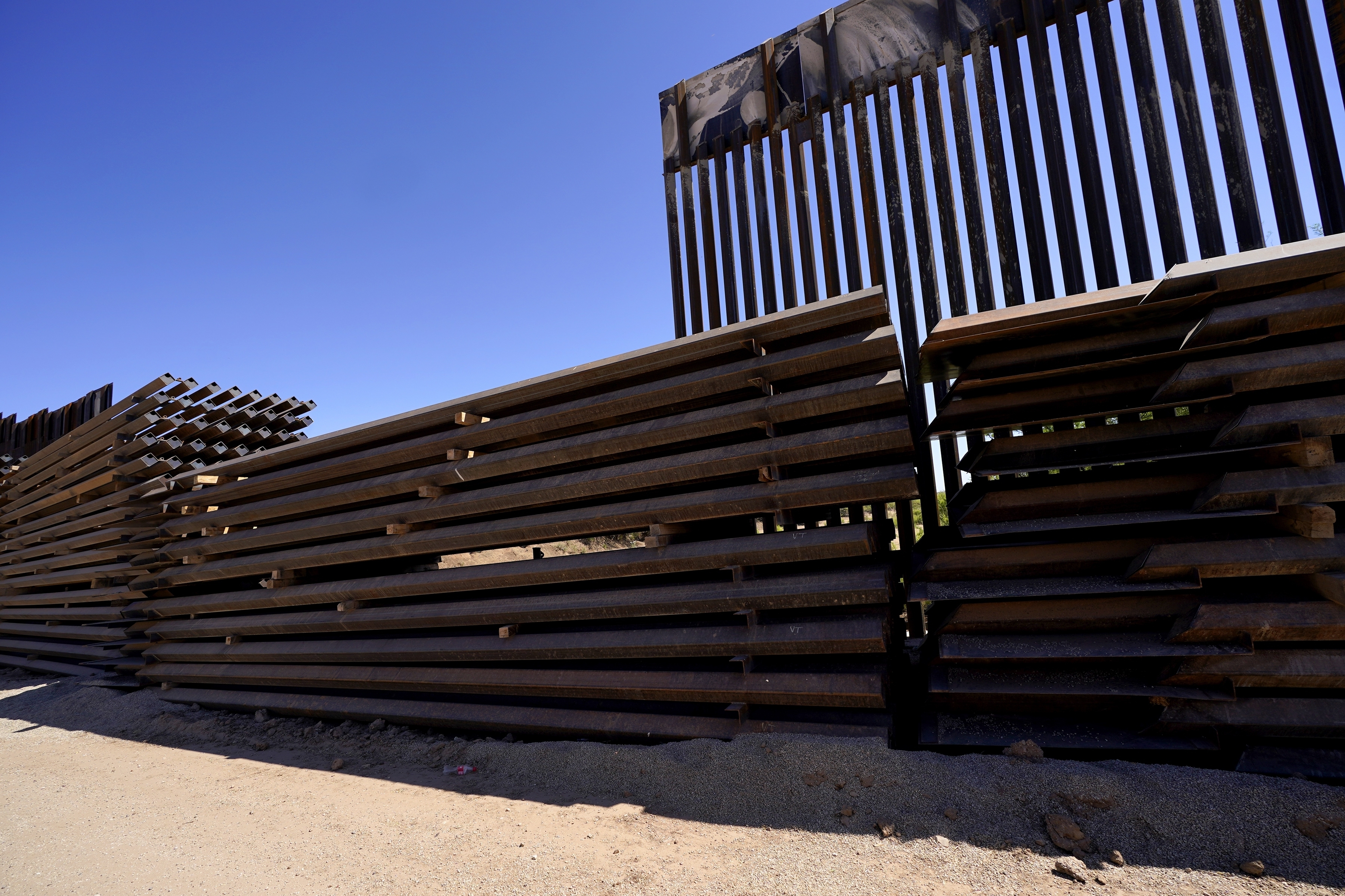 Abandoned border wall construction material is used to close a gap in the newly constructed border wall on May 19, 2021, near Sasabe, Ariz. The Department of Homeland Security Secretary Alejandro Mayorkas announced DHS will use border funding to close wall gaps in areas of Arizona, California and Texas by border construction started by the Trump administration. (Ross D. Franklin/Associated Press)