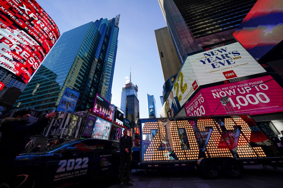 The 2022 sign that will be lit on top of a building on New Year's Eve is displayed in Times Square, New York on Dec. 20, 2021. Revelers will still ring in the new year in New York's Times Square next week, there just won't be as many of them as usual under new restrictions announced Dec. 23, 2021, as the city grapples with a spike in COVID-19 cases. (AP Photo/Seth Wenig, File)