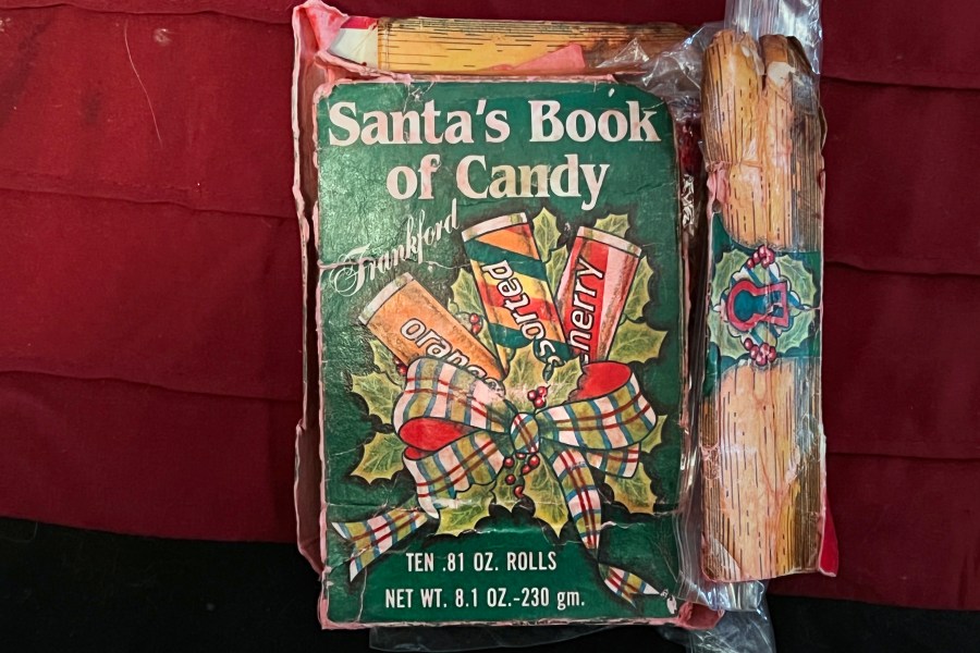 This Ryan Wasson family photograph shows a box of "Santa's Book of Candy," which contains 10 rolls of candy, on Dec. 18, 2021, in Ossipee, N.H. Two New Hampshire brothers have gotten their holiday regifting skills down to an art, and have been passing the same hard candy treats back and forth for over 30 years. Starting in 1987, Ryan Wasson gave the treat to his brother Eric Wasson as a joke for Christmas, knowing that Eric wouldn't like it. (Ryan Wasson family photograph via AP)