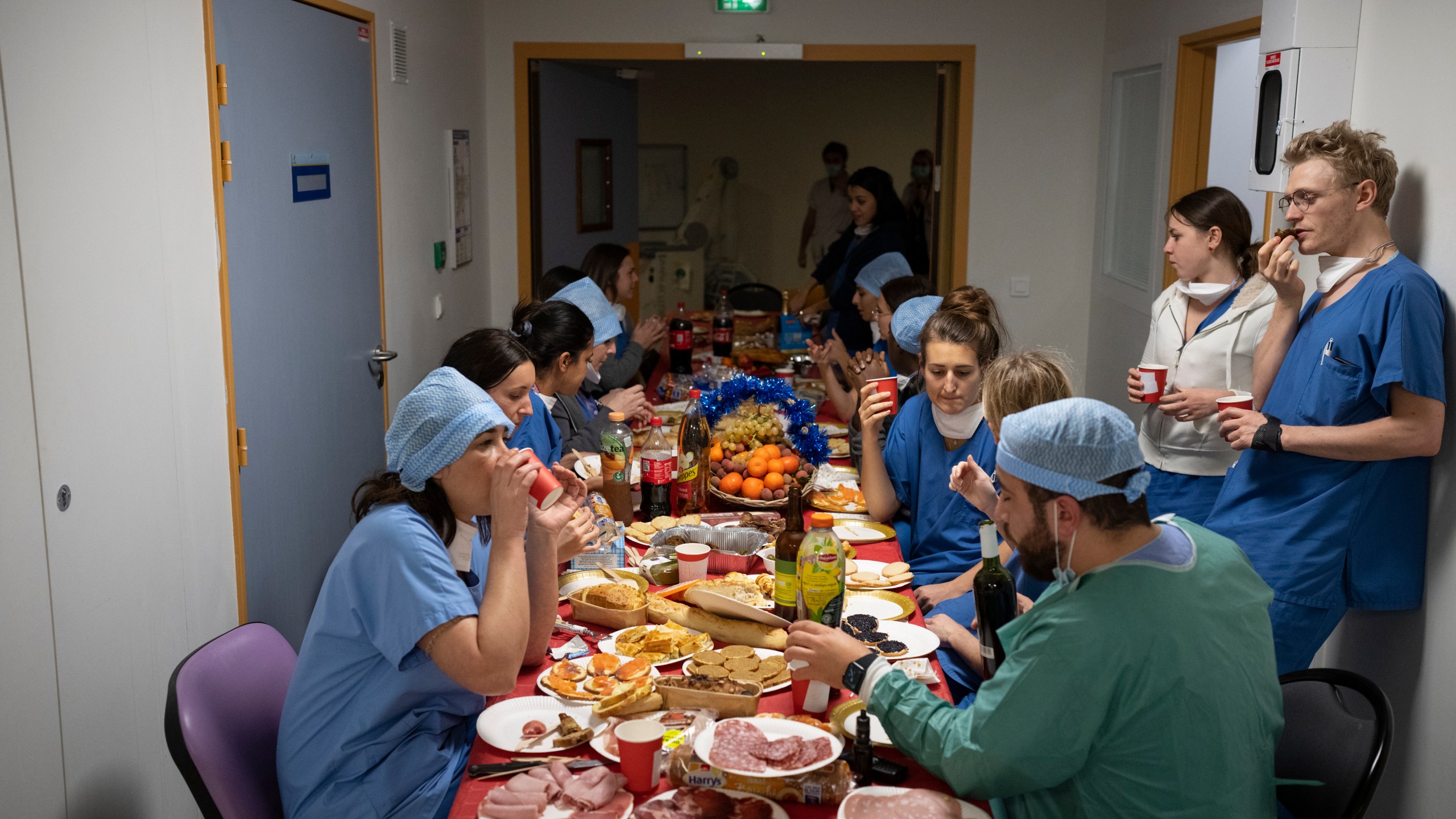 Doctors and nurses share a Christmas Eve meal together in the COVID-19 intensive care unit at la Timone hospital in Marseille, southern France, Friday, Dec. 24, 2021. (AP Photo/Daniel Cole)