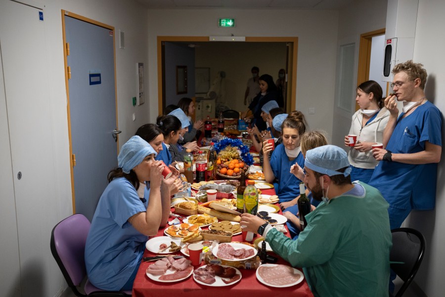 Doctors and nurses share a Christmas Eve meal together in the COVID-19 intensive care unit at la Timone hospital in Marseille, southern France, Friday, Dec. 24, 2021. (AP Photo/Daniel Cole)