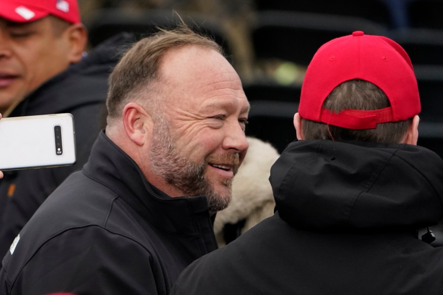 Alex Jones, left, attends a rally in support of President Donald Trump called the "Save America Rally," Wednesday, Jan. 6, 2021, in Washington. The wife of the conspiracy theorist was arrested Friday, Dec. 24, 2021, Christmas Eve on a domestic violence charge that the right-wing provocateur said stems from a “medication imbalance.” (AP Photo/Jacquelyn Martin, File)