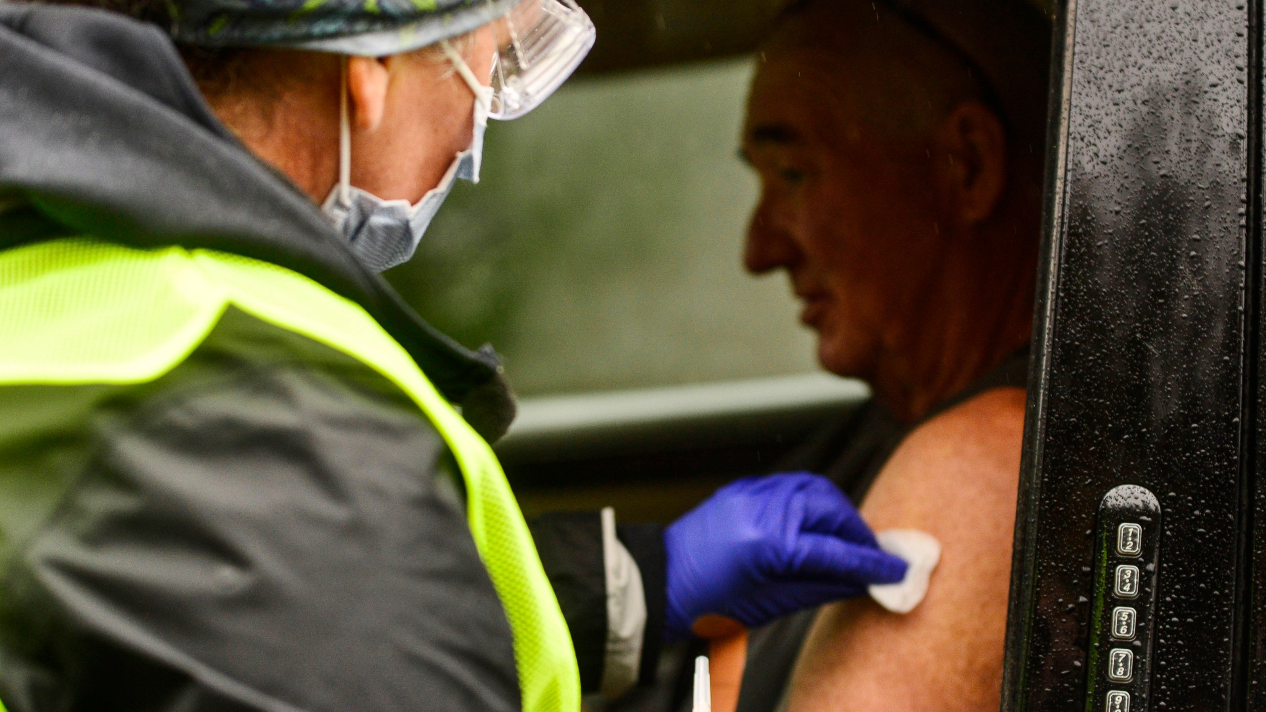 Registered nurse Megan Chamberlain gives a flu shot to Anthony Devitt during a flu vaccine clinic on Route 9, in Brattleboro, Vermont on Oct. 26, 2021. (Kristopher Radder/The Brattleboro Reformer via AP)