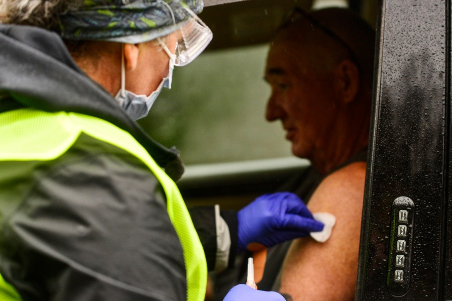 Registered nurse Megan Chamberlain gives a flu shot to Anthony Devitt during a flu vaccine clinic on Route 9, in Brattleboro, Vermont on Oct. 26, 2021. (Kristopher Radder/The Brattleboro Reformer via AP)