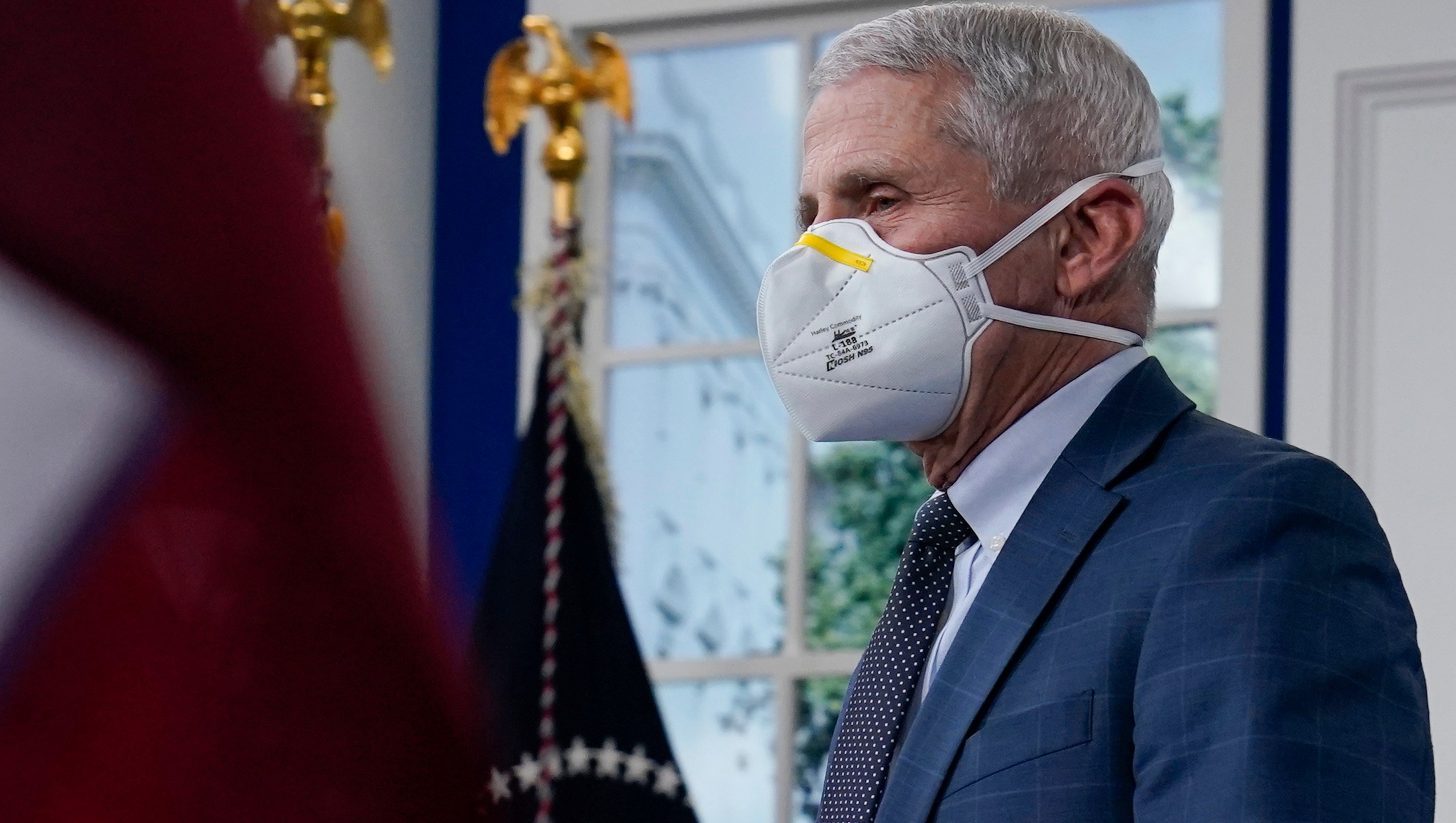 Dr. Anthony Fauci, the top U.S. infectious disease expert, wears a face mask as he arrives for the the White House COVID-19 Response Team's regular call with the National Governors Association in the South Court Auditorium in the Eisenhower Executive Office Building on the White House Campus, Monday, Dec. 27, 2021, in Washington. Fauci says the U.S. should consider a vaccination mandate for domestic air travel as coronavirus infections surge. To date the Biden administration has balked at the idea, anticipating legal entanglements. (AP Photo/Carolyn Kaster)